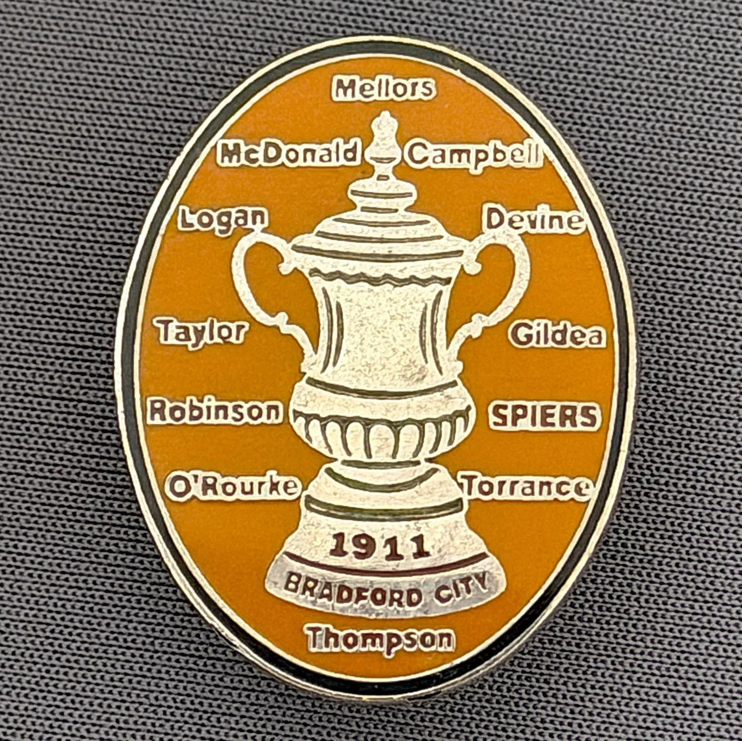 Reference Number: BCEVE014
Size: H 29.5 mm x W 23 mm
Pin Type: Brooch Pin
Plating: Gold
Value: £10
Manufacturer: Unknown
Comments: Amber, 1911 City Cup Winning Squad