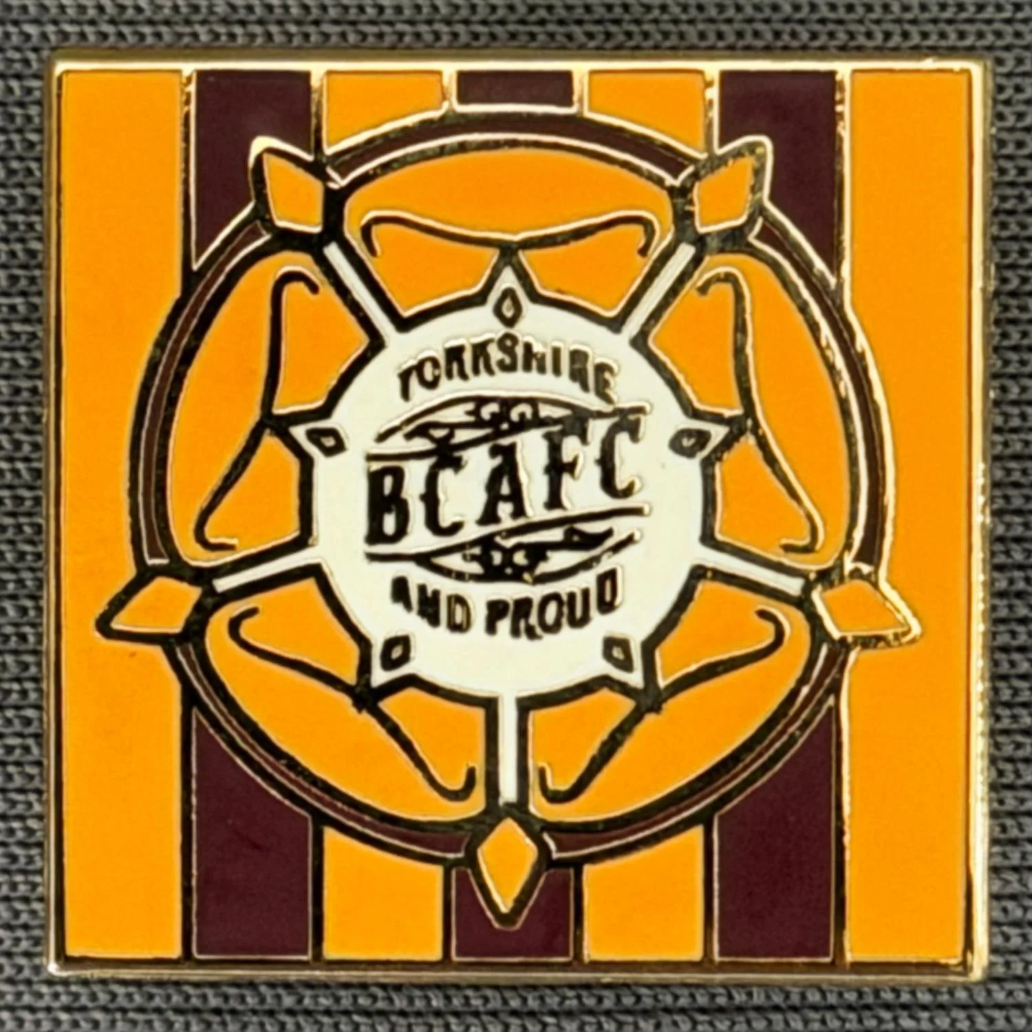 Reference Number: BCYR032
Size: H 20.1 mm x W 20.4 mm
Pin Type: Brooch Pin
Plating: Gold
Value: £6
Manufacturer: Unknown
Comments: Claret & Amber Striped, Amber & White Yorkshire Rose, BCAFC and Proud