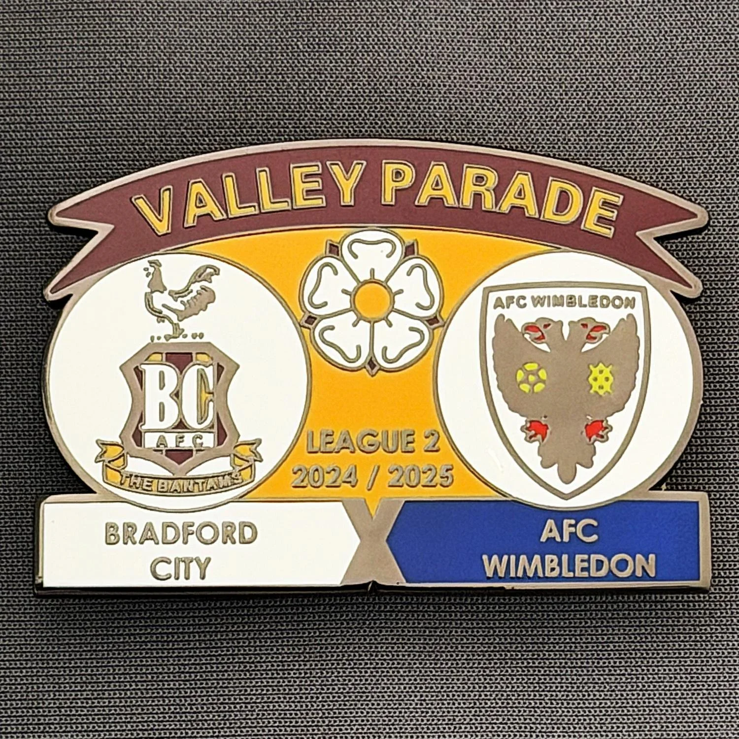 Reference Number: BCFIX419
Size: H 34.3 mm x W 50 mm
Pin Type: Brooch Pin
Plating: Black Nickel
Value: £5
Manufacturer: Unknown
Comments: Bradford City v AFC Wimbledon 2024/25.
