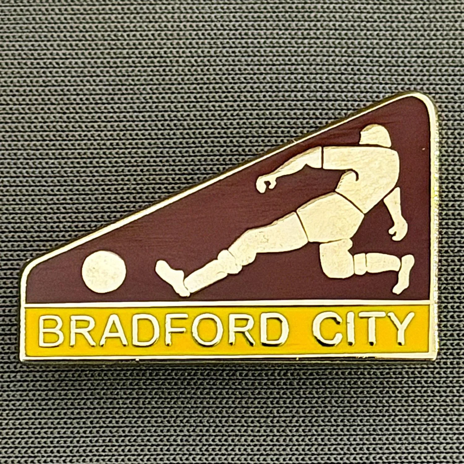 Reference Number: BCBCFC077
Size: H 17.3 mm x W 26.2 mm
Pin Type: Brooch Pin
Plating: Silver
Value: £6
Manufacturer: Andy Stokes
Comments: Claret & Amber Bradford City Footballer
