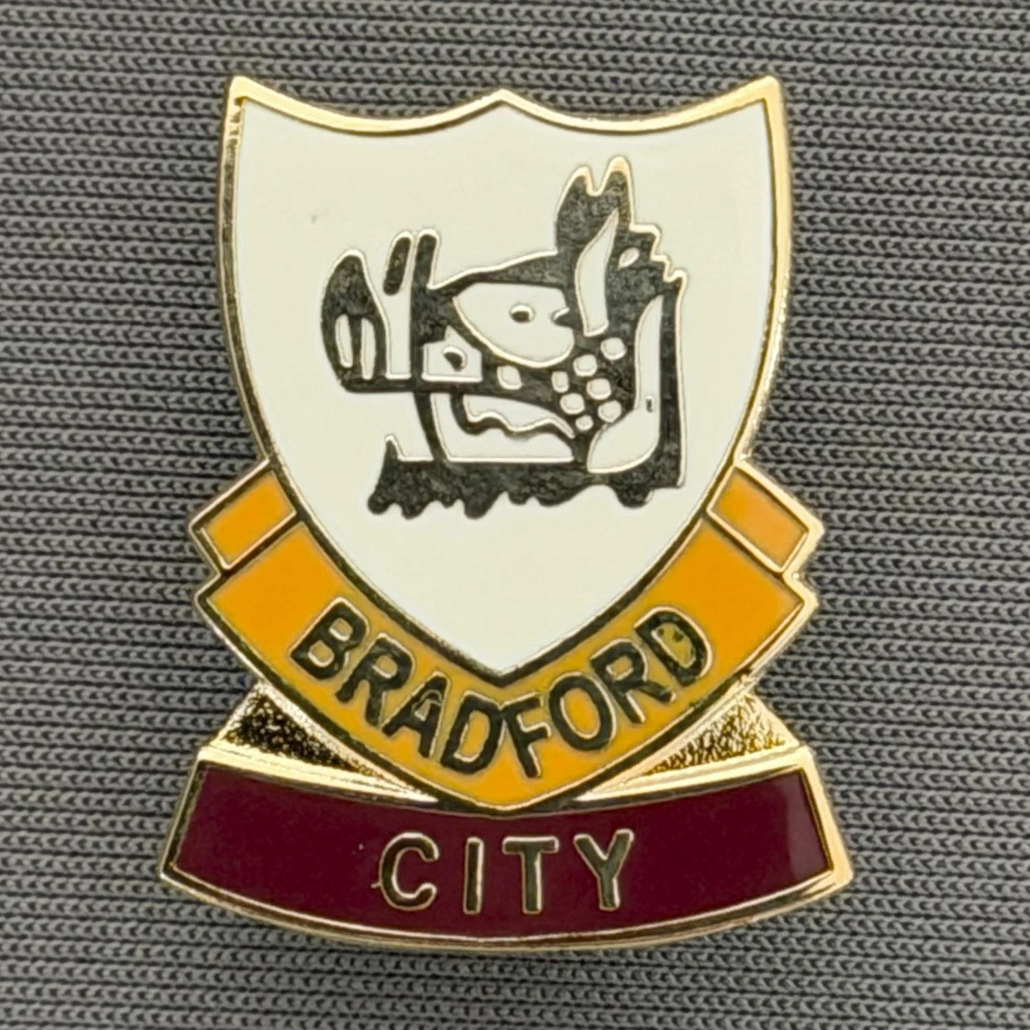 Reference Number: BCBOH060
Size: H 23.8 x W 19.1 mm
Pin Type: Brooch Pin
Plating: Gold
Value: £6
Manufacturer: Unknown
Comments: White, Amber & Claret Boar's Head Shield
