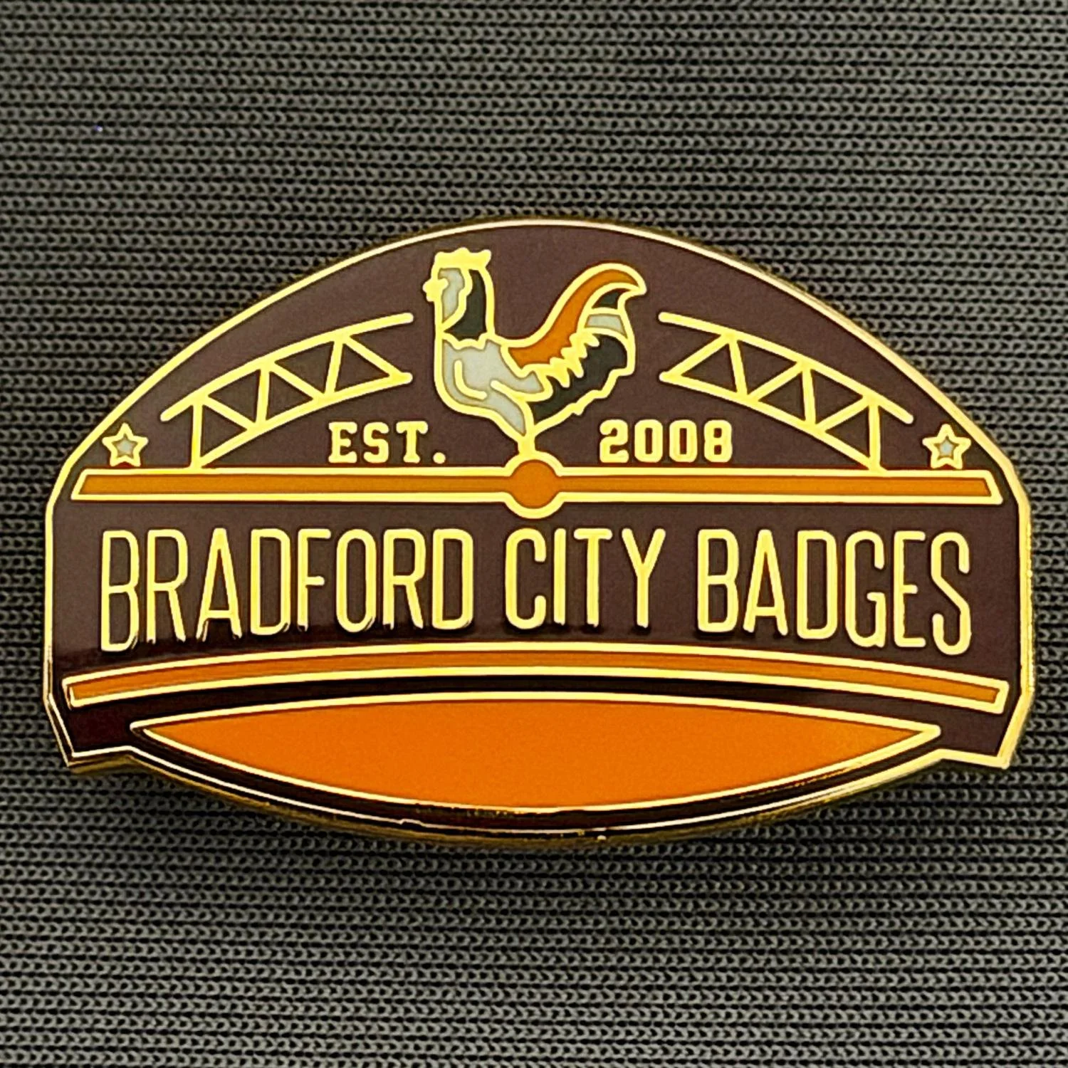 Reference Number: BCUN050
Size: H 20.5 mm x W 32 mm
Pin Type: Metal Clutch
Plating: Gold
Value: £6
Manufacturer: Bradford City Badges
Comments: Bradford City Badges Badge, Limited Edition of 90.