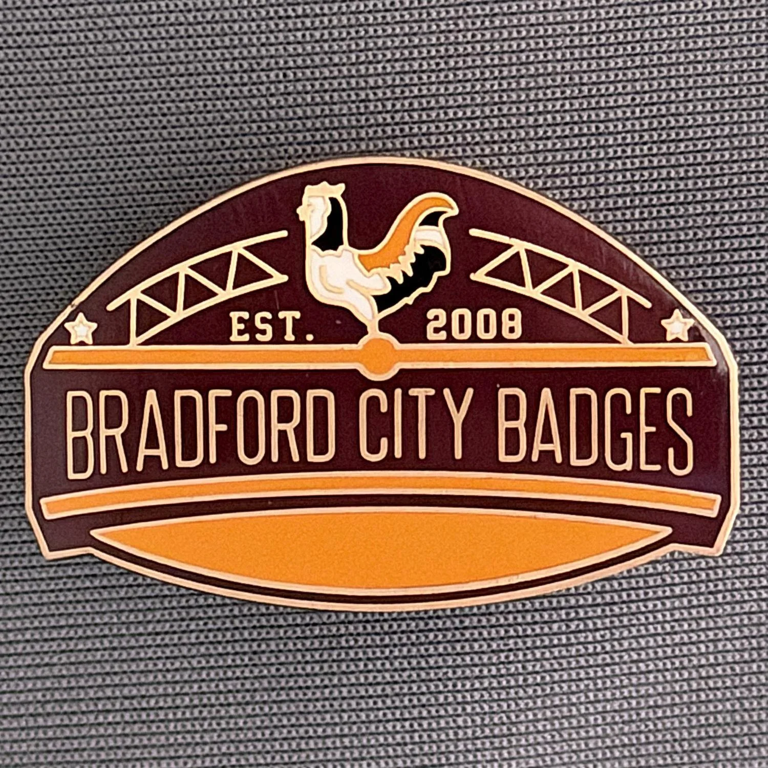 Reference Number: BCUN054
Size: H 20.5 mm x W 32 mm
Pin Type: Metal Clutch
Plating: Antique Bronze
Value: £10
Manufacturer: Bradford City Badges
Comments: Bradford City Badges Badge, Limited Edition of 1.