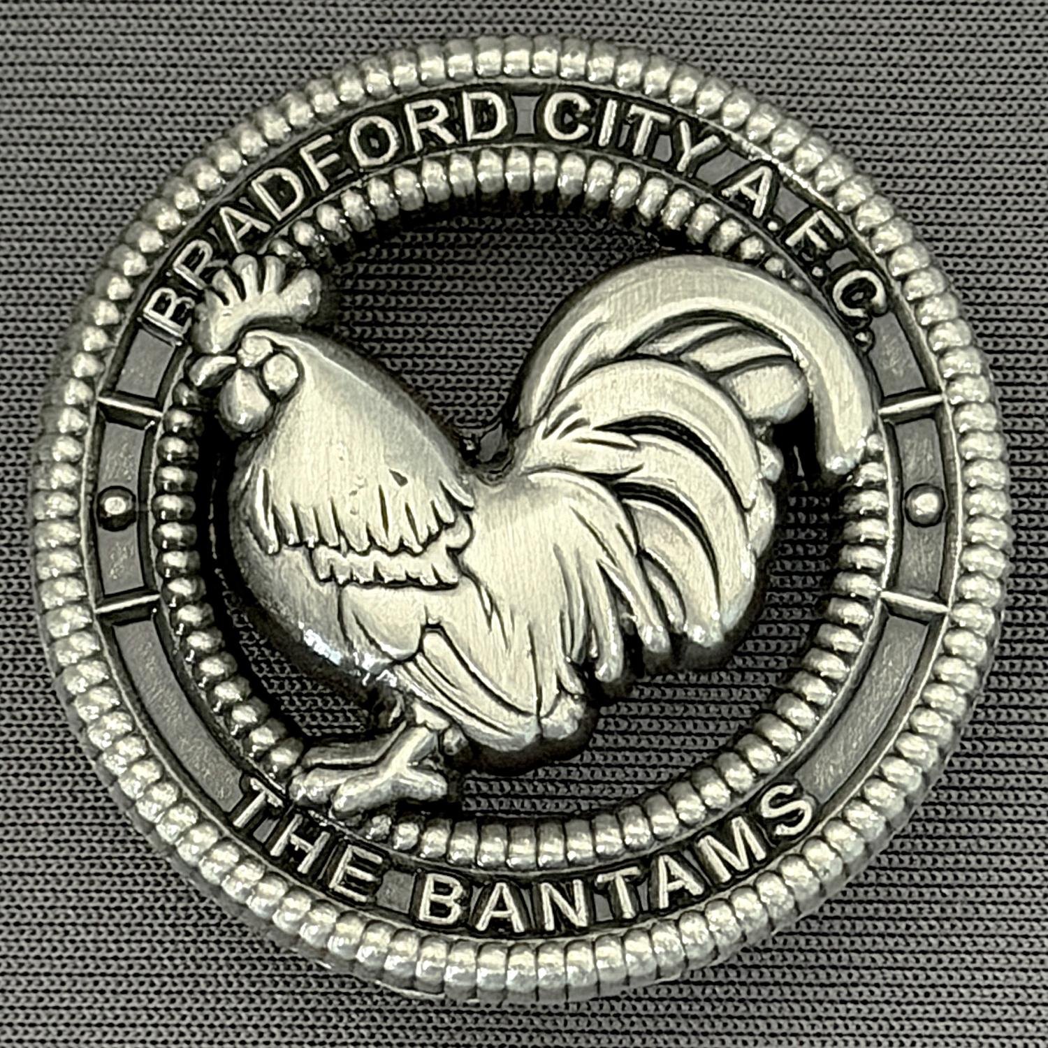 Reference Number: BCBAN081
Size: D 35.3 mm
Pin Type: Brooch Pin
Plating: Antique Silver
Value: £8
Manufacturer: Bradford City Badges
Comments: 3D Antique Silver, Cut out Bantam. Limited Edition of 12 Badges.