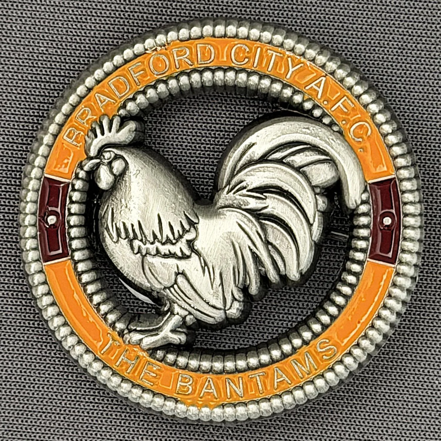 Reference Number: BCBAN072
Size: D 35.3 mm
Pin Type: Brooch Pin
Plating: Antique Silver
Value: £12
Manufacturer: Bradford City Badges
Comments: 3D Amber & Claret, Cut Out Bantam. Limited Edition of 6 Badges.