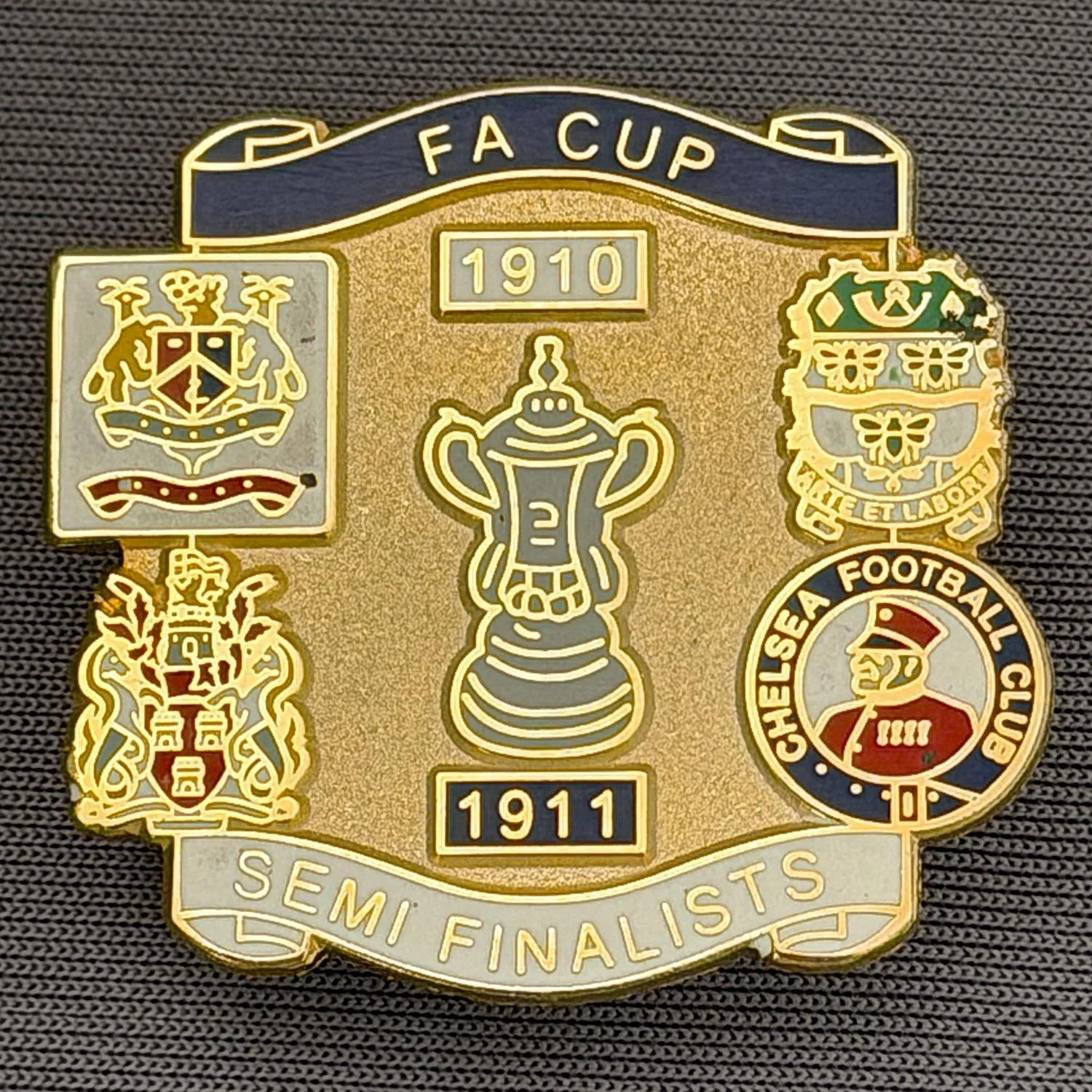 Reference Number: BCFAC032
Size: H 29.1 mm x W 31.3 mm
Pin Type: Brooch Pin
Plating: Gold
Value: £6
Manufacturer: Unknown
Comments: 1910-1911, F.A. Cup Semi Finalists Dark Blue & White Version