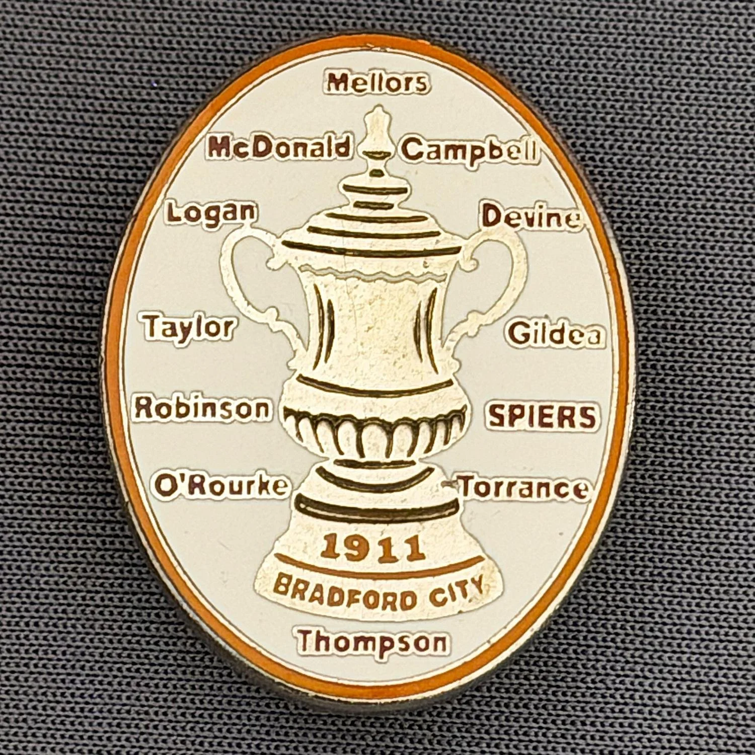 Reference Number: BCEVE017
Size: H 29.5 mm x W 23 mm
Pin Type: Brooch Pin
Plating: Gold
Value: £10
Manufacturer: Unknown
Comments: White, 1911 City Cup Winning Squad, Claret Text.