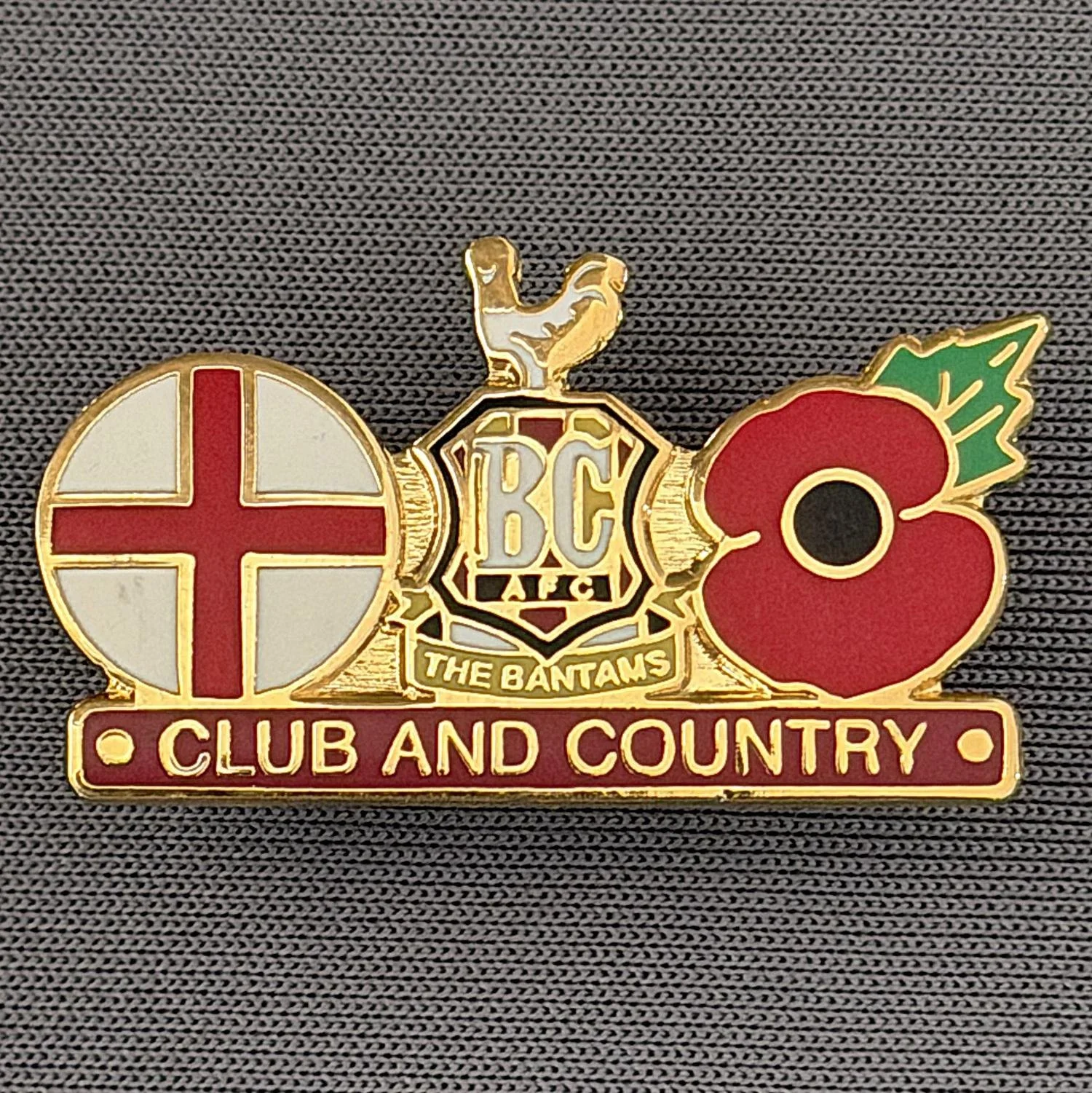 Reference Number: BCMUL023
Size: H 16.9 mm x W 30 mm
Pin Type: Brooch Pin
Plating: Gold
Value: £6
Manufacturer: Unknown
Comments: City Logo, St George's Cross, Poppy, Club & Country