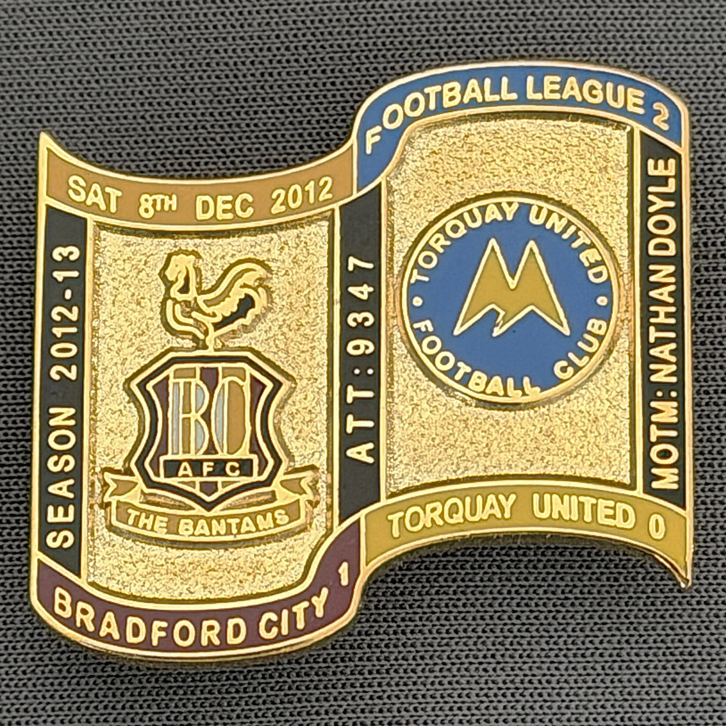 Reference Number: BCFIX126
Size: H 26.9 mm x W 29.2 mm
Pin Type: Brooch Pin
Plating: Gold
Value: £8
Manufacturer: Bradford City Badges
Comments: Bradford City v Torquay United 2012/13 Limited Edition 65 Badges