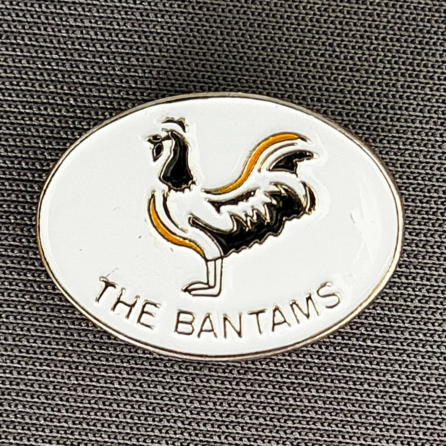 Reference Number: BCBAN010
Size: H 14.6 mm x W 20 mm
Pin Type: Brooch Pin
Plating: Brass
Value: £8
Manufacturer: Unknown
Comments: Oval Bantams Small Version