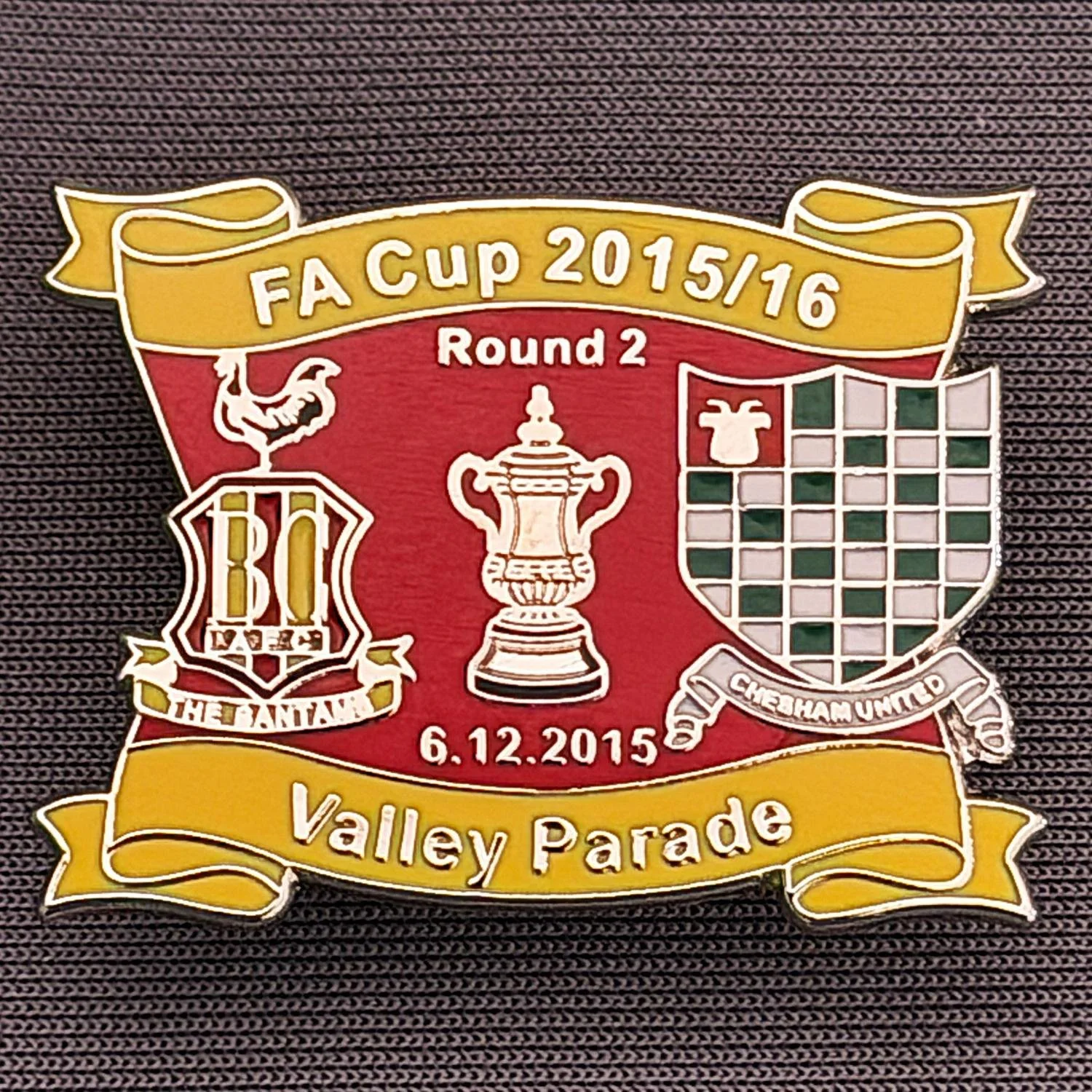 Reference Number: BCFAC142
Size: H 24.5 mm x W 32.5 mm
Pin Type: Metal Clutch
Plating: Silver
Value: £4
Manufacturer: Dan Lloyd
Comments: F.A. Cup Second Round 2015/16 v Chesham United, Amber & Red Version
