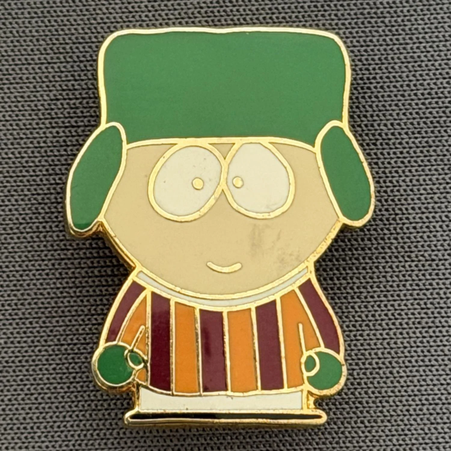 Reference Number: BCCTN021
Size: H 24.9 mm x W 19.1 mm
Pin Type: Brooch Pin
Plating: Gold
Value: £6
Manufacturer: Not Known
Comments: Kyle Broflovski South Park in Bradford City Kit