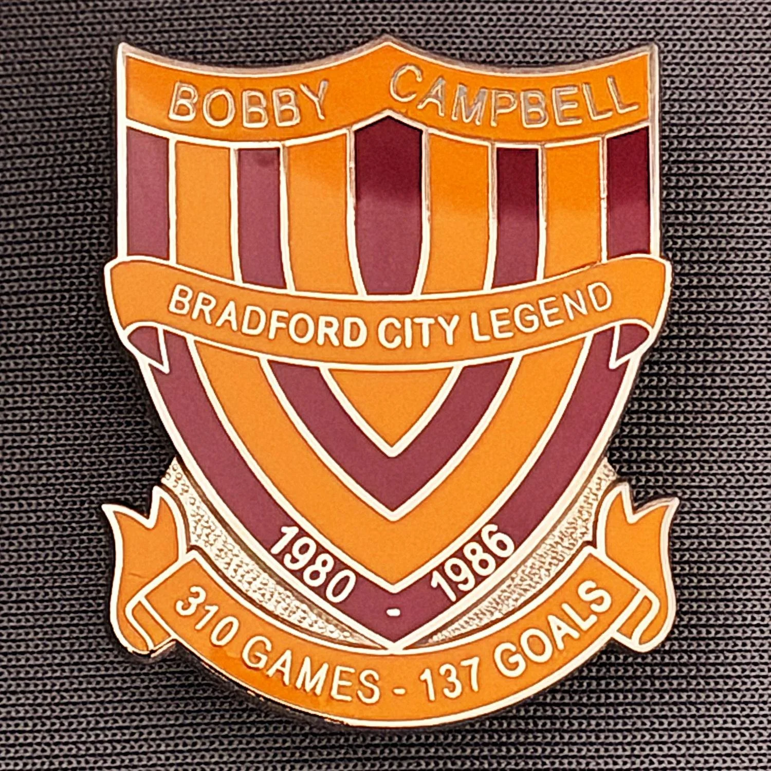 Reference Number: BCUN017
Size: H 32 mm x W 25.9 mm
Pin Type: Metal Clutch
Plating: Silver
Value: £10
Manufacturer: Bradford City Badges
Comments: Bobby Campbell Limited Edition of 25. Boxed Set of 4. Issued 2012. Amber & Claret Version.