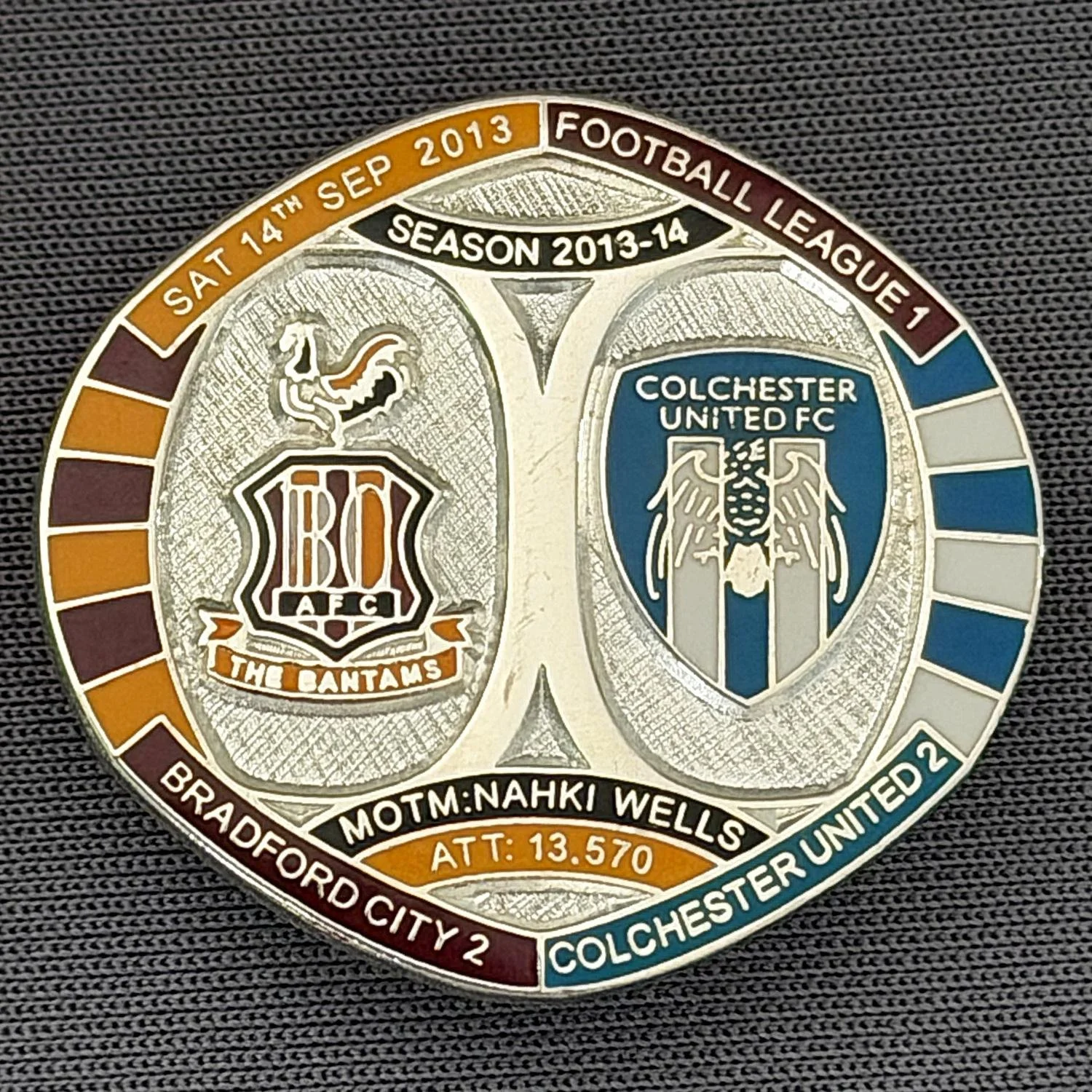 Reference Number: BCFIX211
Size: H 26.3 mm x W 28.9 mm
Pin Type: Brooch Pin
Plating: Silver
Value: £10
Manufacturer: Bradford City Badges
Comments: Bradford City v Colchester  United  2013/14 Limited Edition 10 Badges (Silver Version)