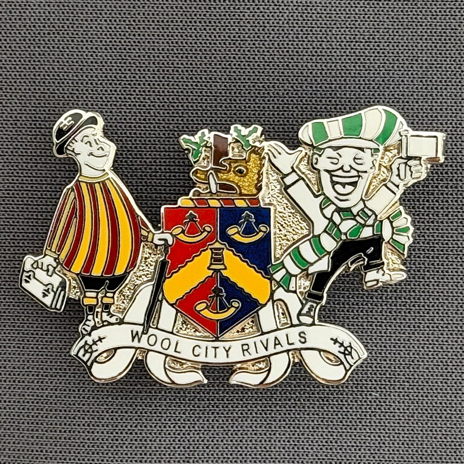 Reference Number: BCEVE043
Size: H 23.8 mm x W 36 mm
Pin Type: Brooch Pin
Plating: Silver
Value: £8
Manufacturer: Paraders
Comments: Wool City Rivals, City Gent & Avenue Arry