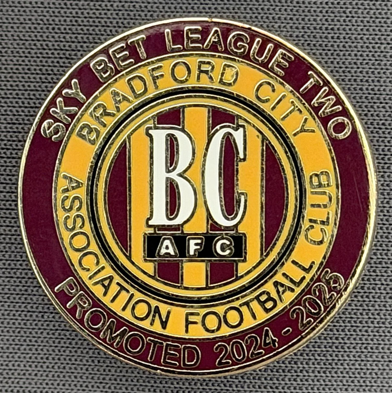 Reference Number: BCEVE072
Size: D 24.2 mm
Pin Type: Metal Clutch
Plating: Gold
Value: £8
Manufacturer: Dave Horn
Comments: Promoted From Division 2, 2024-25, Claret & Amber. Boxed Set Limited Edition of 75