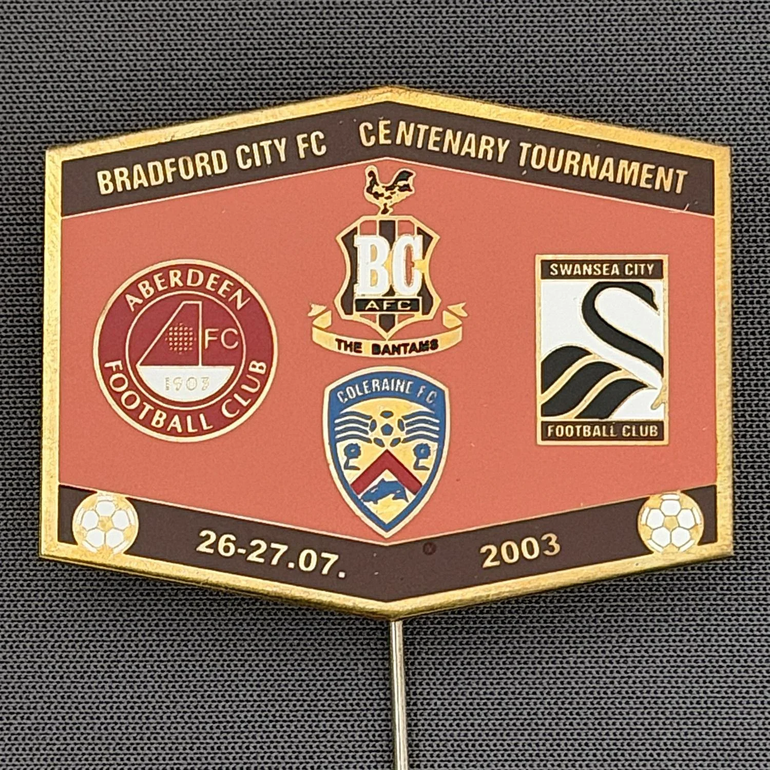 Reference Number: BCEVE019
Size: H 31.5 mm x W 39.6 mm
Pin Type: Stick Pin
Plating: Brass
Value: £12
Manufacturer: Russian
Comments: Centenary Tournament 2003, Claret & Orange Version.