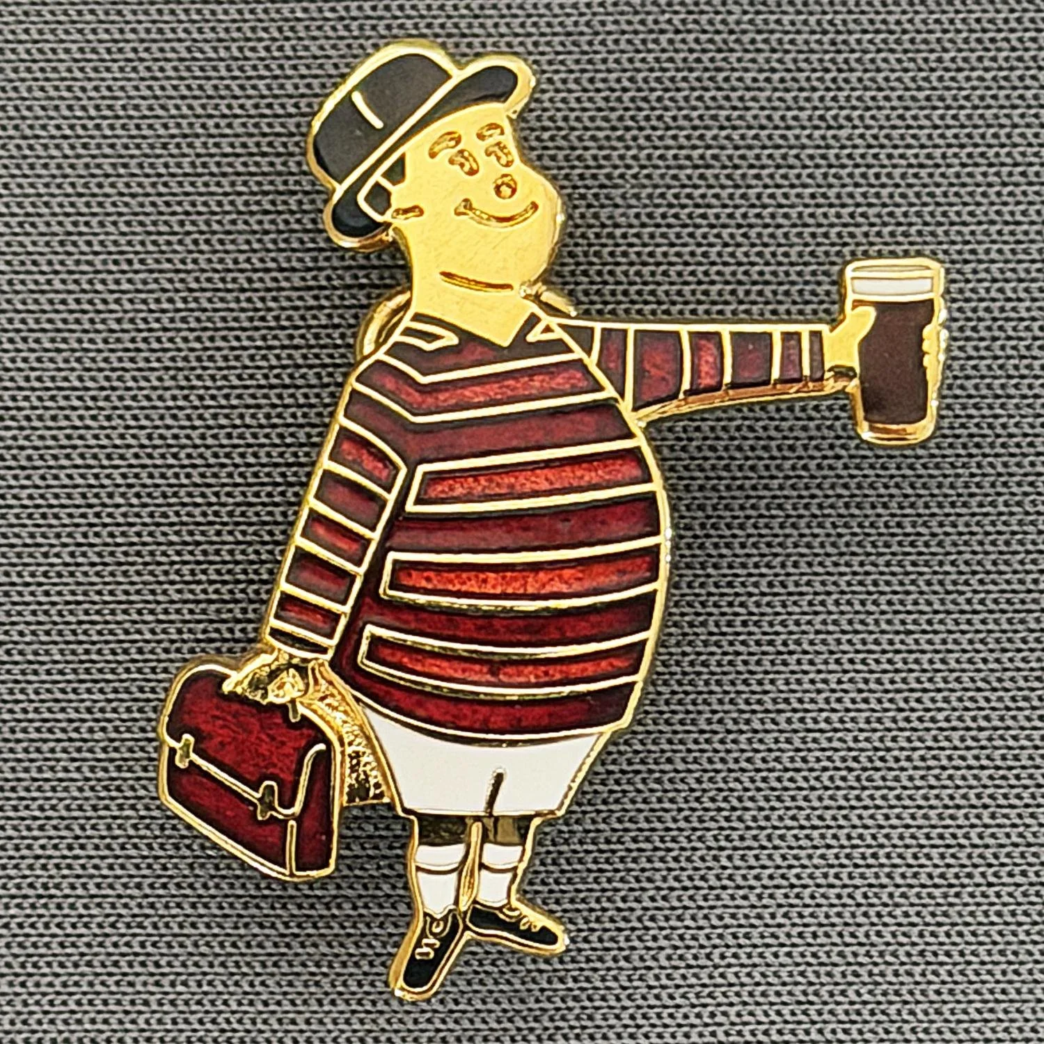 Reference Number: BCGEN063
Size: H 28.8 mm x W 20.9 mm
Pin Type: Brooch Pin
Plating: Gold
Value: £20
Manufacturer: Bradford City Badges
Comments: City Gent Beer Cloisonne, Claret Briefcase. One Off Badge.