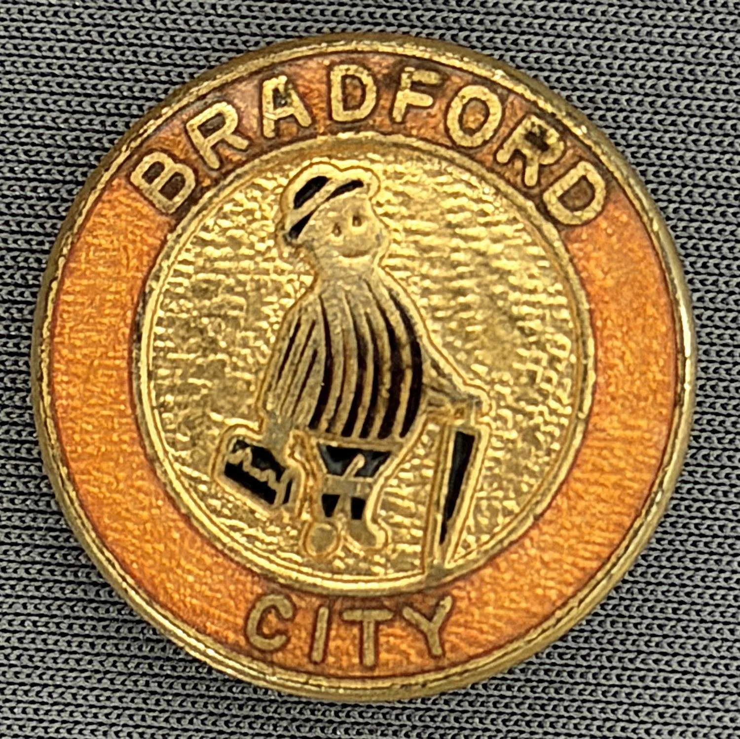 Reference Number: BCGEN017
Size: D 25.3 mm
Pin Type: Brooch Pin
Plating: Gold
Value: £10
Manufacturer: Unknown
Comments: Circular City Poor Quality Gent, Amber Version