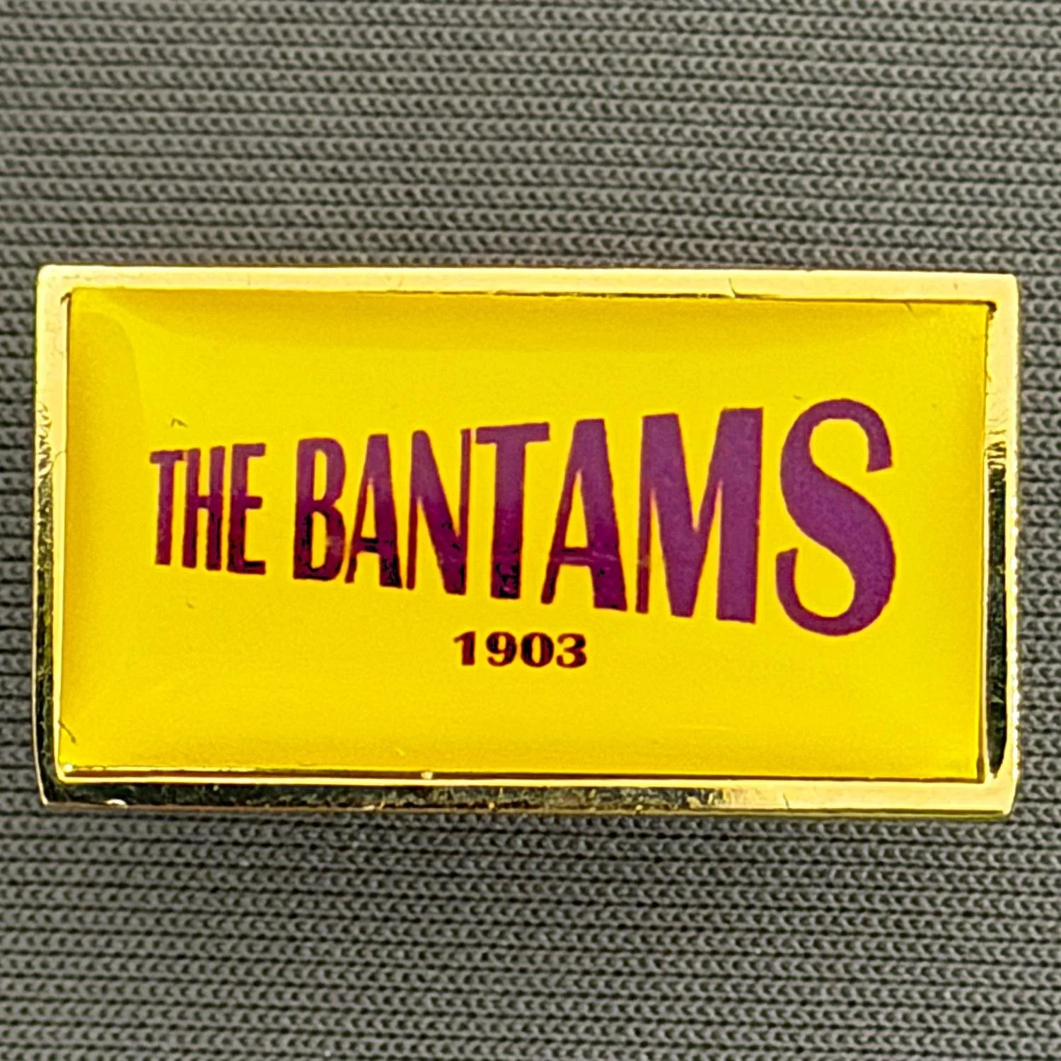 Reference Number: BCBCFC068
Size: H 13.7 mm x W 24.6 mm
Pin Type: Brooch Pin
Plating: Gold
Value: £4
Manufacturer: Unknown
Comments: The Bantams 1903, Amber & Claret, Plastic Dome