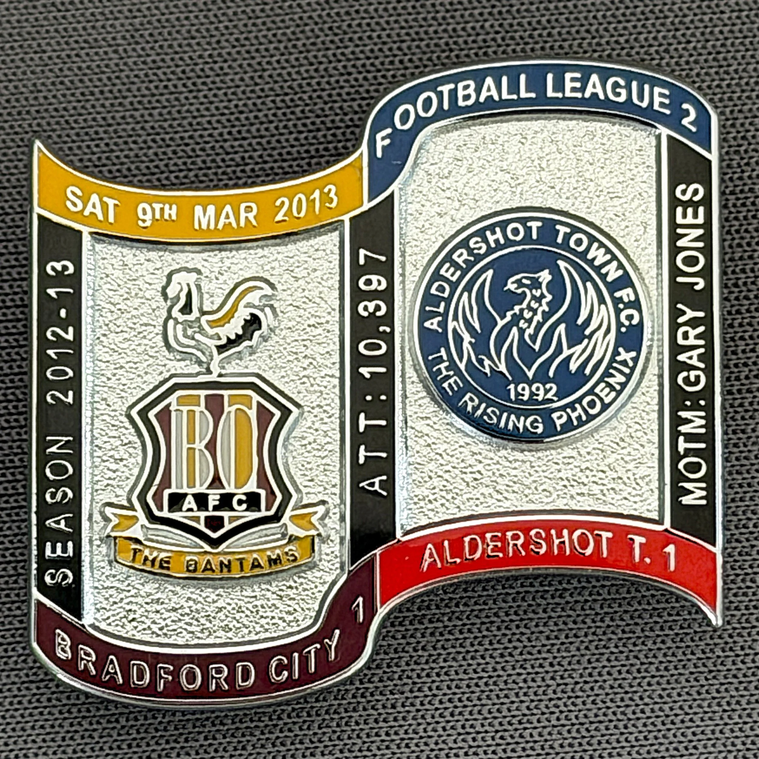 Reference Number: BCFIX155
Size: H 26.9 mm x W 29.2 mm
Pin Type: Brooch Pin
Plating: Chrome
Value: £10
Manufacturer: Bradford City Badges
Comments: Bradford City v Aldershot Town  2012/13 Limited Edition 10 Badges (Silver Version)