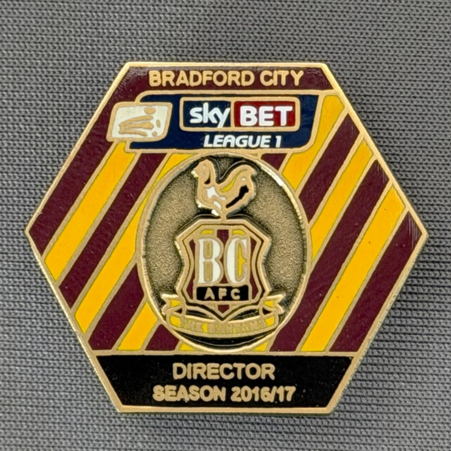 Reference Number: BCDIR013
Size: H 25.7 mm x W 29.5 mm
Pin Type: Brooch Pin
Plating: Antique Gold
Value: £30
Manufacturer: Bradford City Badges
Comments: Worn by Associate Directors