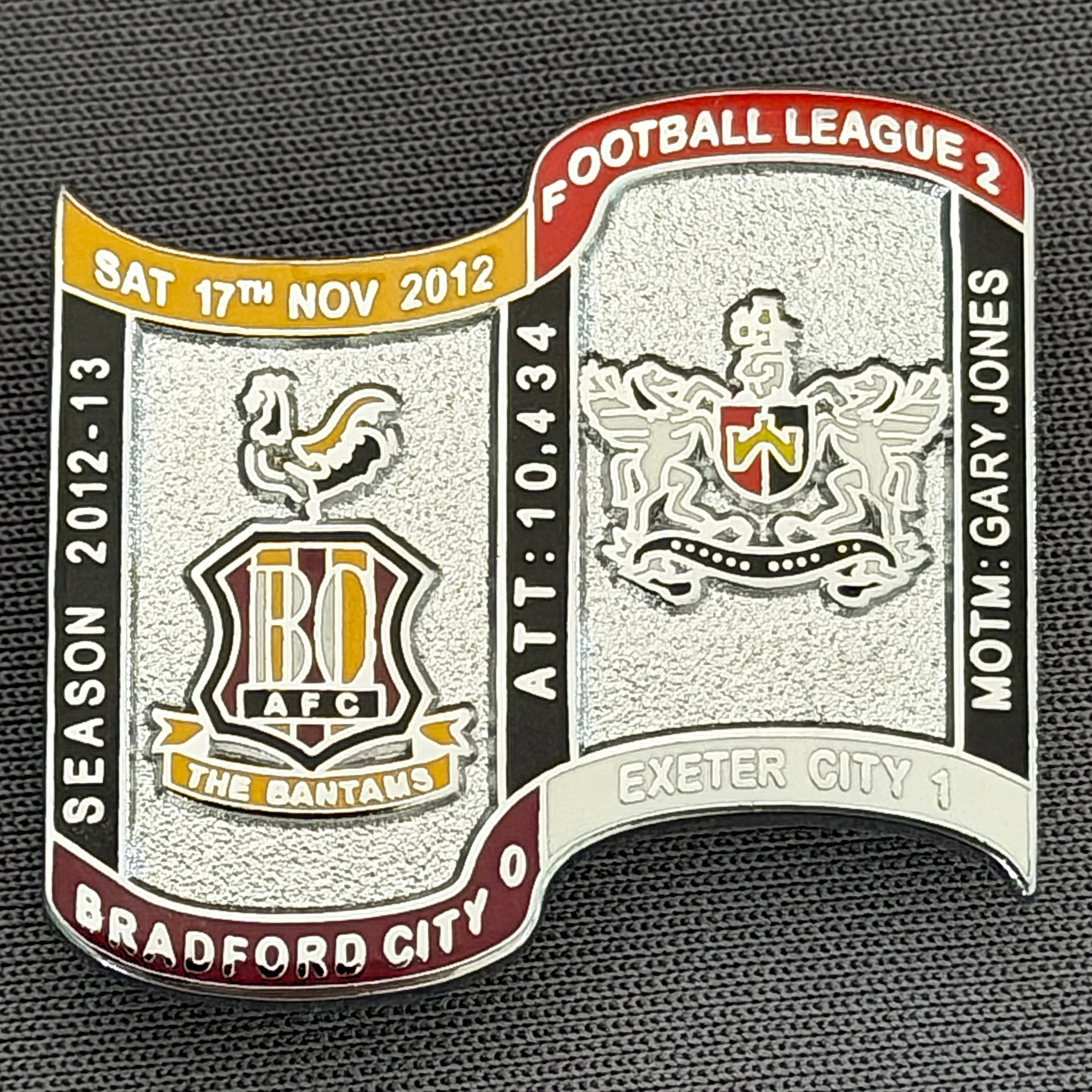 Reference Number: BCFIX147
Size: H 26.9 mm x W 29.2 mm
Pin Type: Brooch Pin
Plating: Chrome
Value: £10
Manufacturer: Bradford City Badges
Comments: Bradford City v Exeter City  2012/13 Limited Edition 10 Badges (Silver Version)