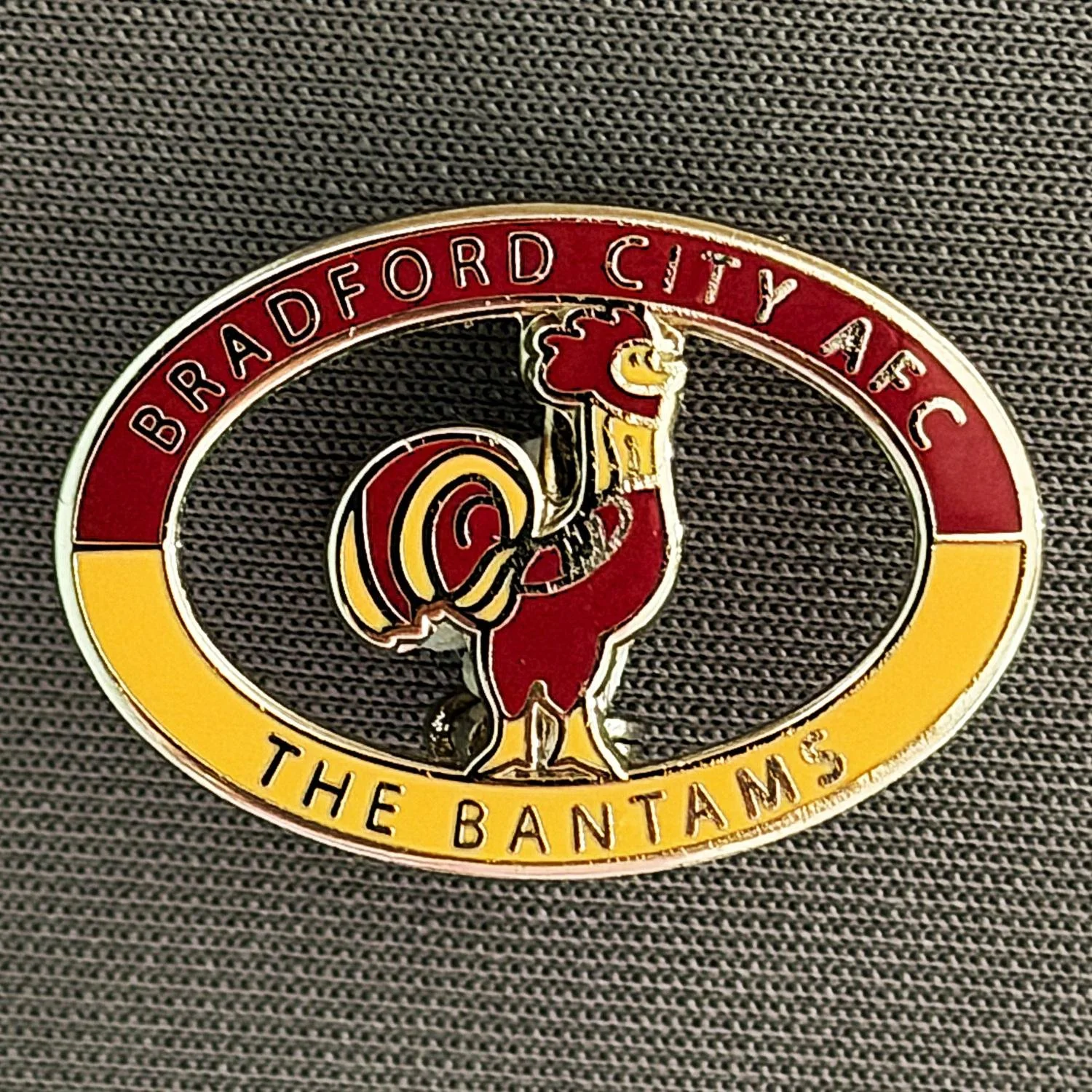 Reference Number: BCC&L064
Size: H 17.4 mm x 25.3  mm
Pin Type: Brooch Pin
Plating: Silver
Value: £8
Manufacturer: Paraders
Comments: Oval Bantams Logo