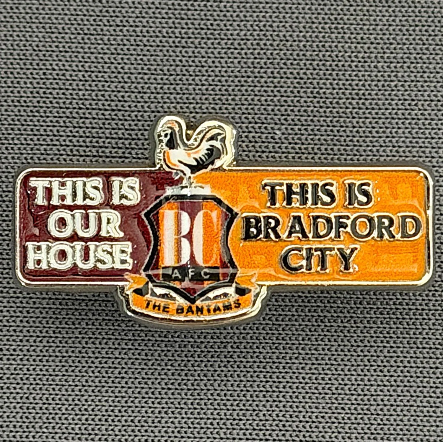 Reference Number: BCC&L167
Size: H 13.1 mm x 25.6 mm
Pin Type: Metal Clutch
Plating: Silver
Value: £6
Manufacturer: Bradford City Shop
Comments: City Logo, This is Our House
