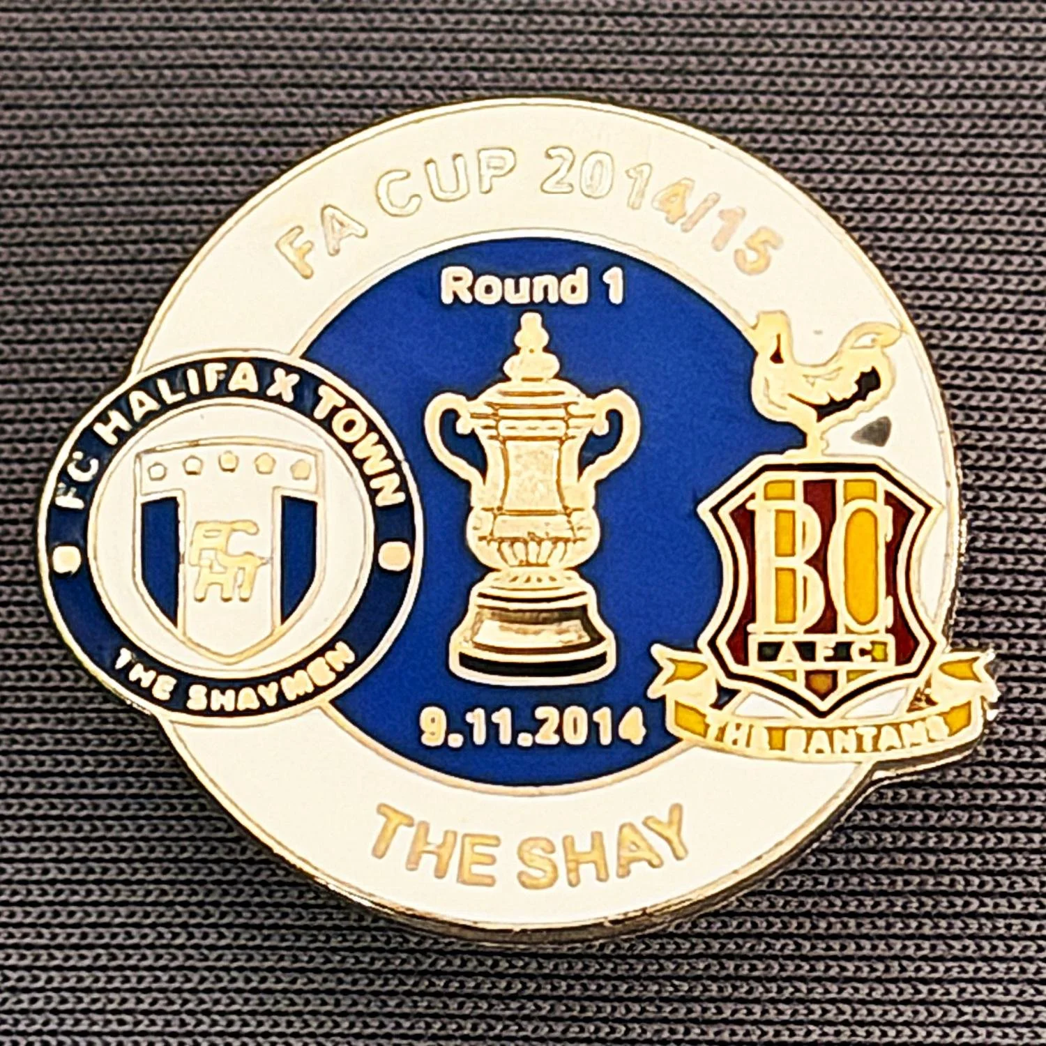 Reference Number: BCFAC059
Size: H 22. 7 mm x W 25.8 mm
Pin Type: Metal Clutch
Plating: Silver
Value: £4
Manufacturer: Dan Lloyd
Comments: F.A. Cup 2014/15 Away v Halifax Town, White & Blue Version
