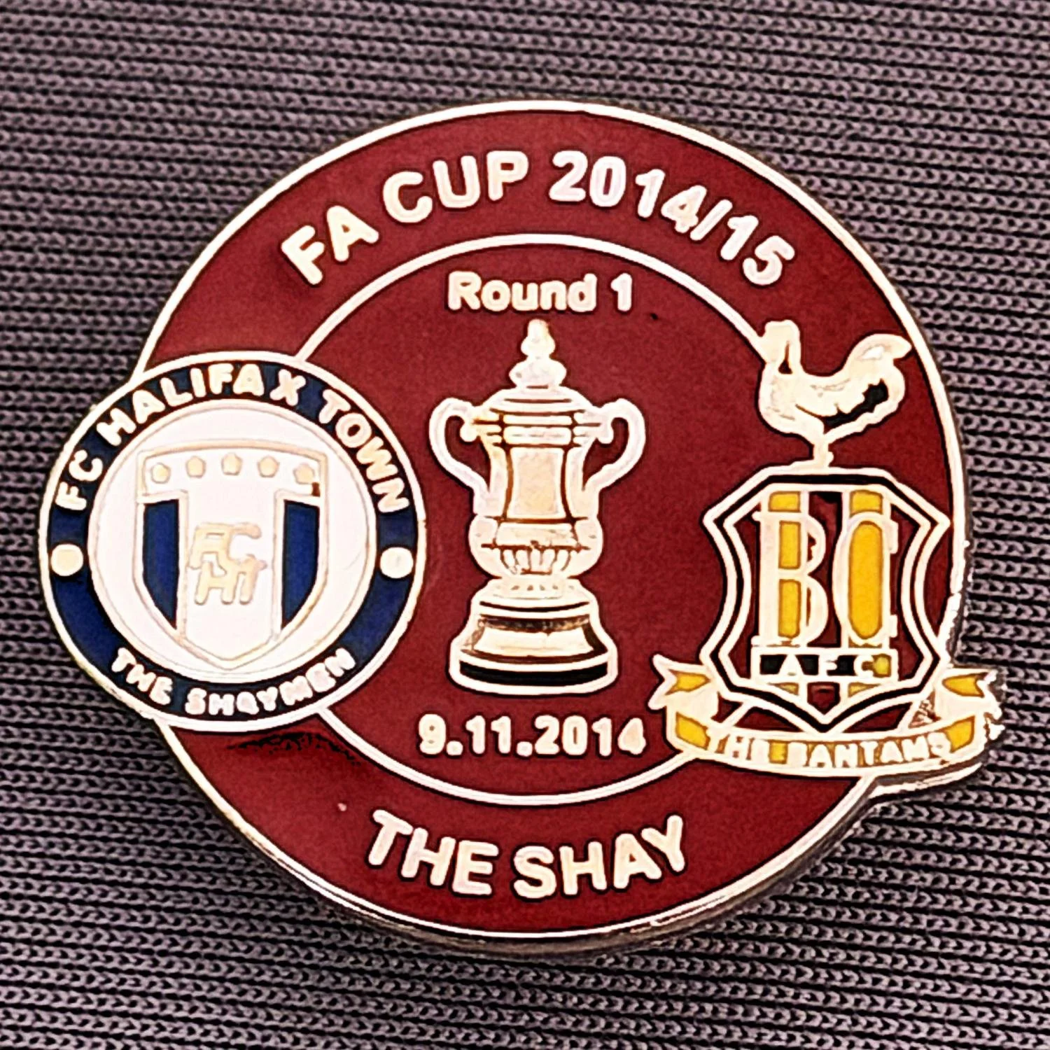 Reference Number: BCFAC054
Size: H 22. 7 mm x W 25.8 mm
Pin Type: Metal Clutch
Plating: Silver
Value: £4
Manufacturer: Dan Lloyd
Comments: F.A. Cup 2014/15 Away v Halifax Town, Claret Version