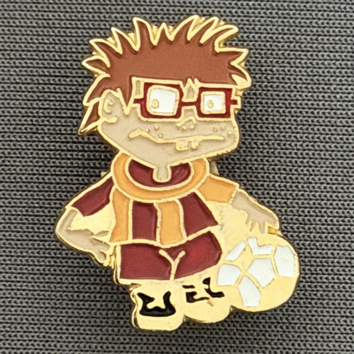 Reference Number: BCCTN008
Size: H 22.4 mm x W 17.3 mm
Pin Type: Brooch Pin
Plating: Gold
Value: £6
Manufacturer: Not Known
Comments: Chuckle Rugrat in Bradford City Kit
