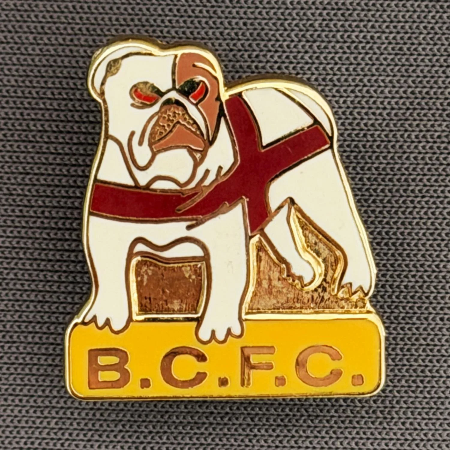 Reference Number: BCFLA027
Size: H 19 mm x W 17.5 mm
Pin Type: Metal Clutch
Plating: Gold
Value: £6
Manufacturer: Not Known
Comments: British Bulldog with St George Crest and BCFC Amber Version