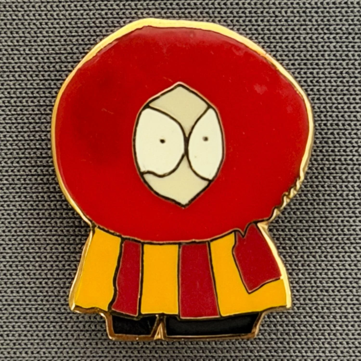 Reference Number: BCCTN022
Size: H 21.8 mm x W 18 mm
Pin Type: Brooch Pin
Plating: Gold
Value: £6
Manufacturer: Not Known
Comments: Kenny McKormick South Park in Bradford City Kit