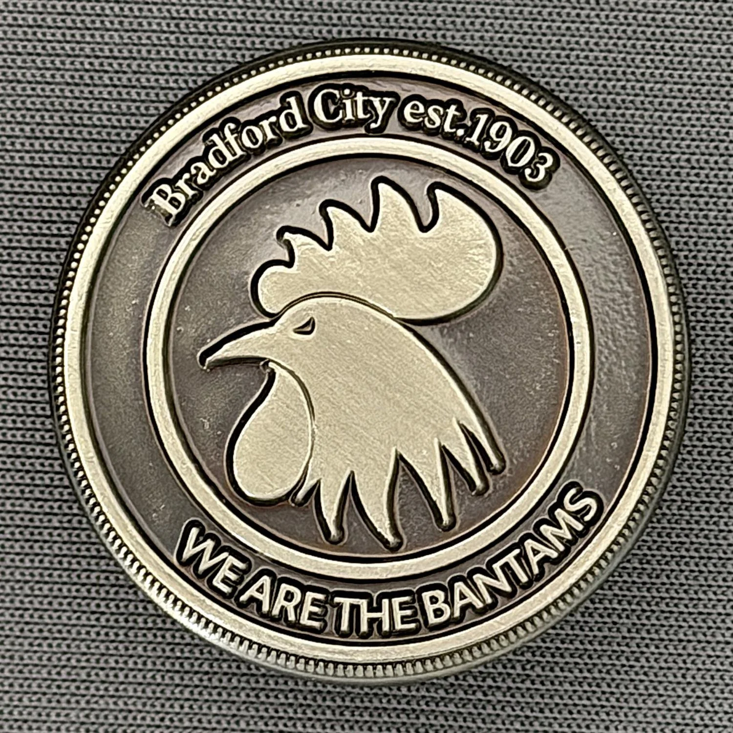 Reference Number: BCBAN067
Size: D 26.8 mm
Pin Type: Metal Clutch
Plating: Black Nickel
Value: £6
Manufacturer: Bradford City Shop
Comments: Circular, We Are The Bantams Crest