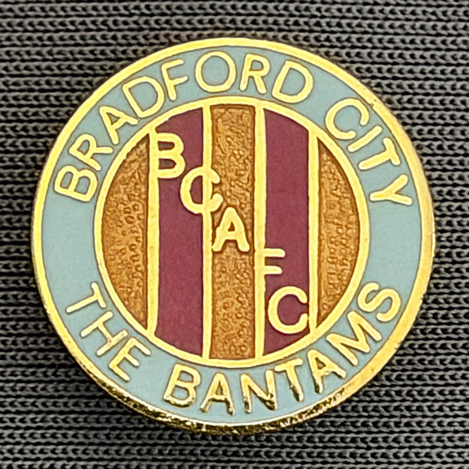Reference Number: BCBCFC015
Size: D 15.2 mm
Pin Type: Brooch Pin
Plating: Gold
Value: £8
Manufacturer: Unknown
Comments: Bradford City, BCAFC, The Bantams, Blue, Claret & Amber Version