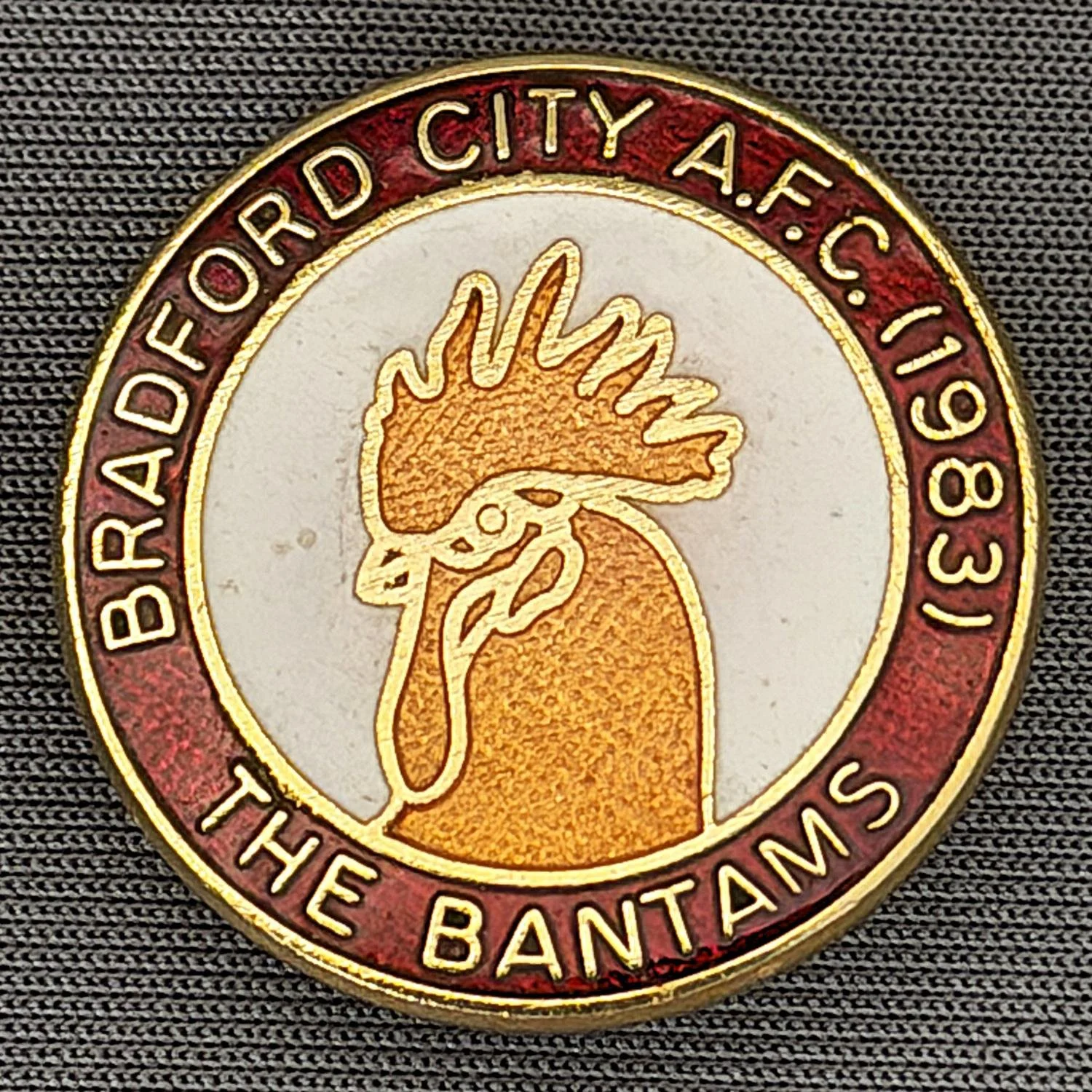 Reference Number: BCBAN003
Size: D 25.4 mm
Pin Type: Brooch Pin
Plating: Gold
Value: £12
Manufacturer: Unknown
Comments: Bradford City 1983 Bantam Crest