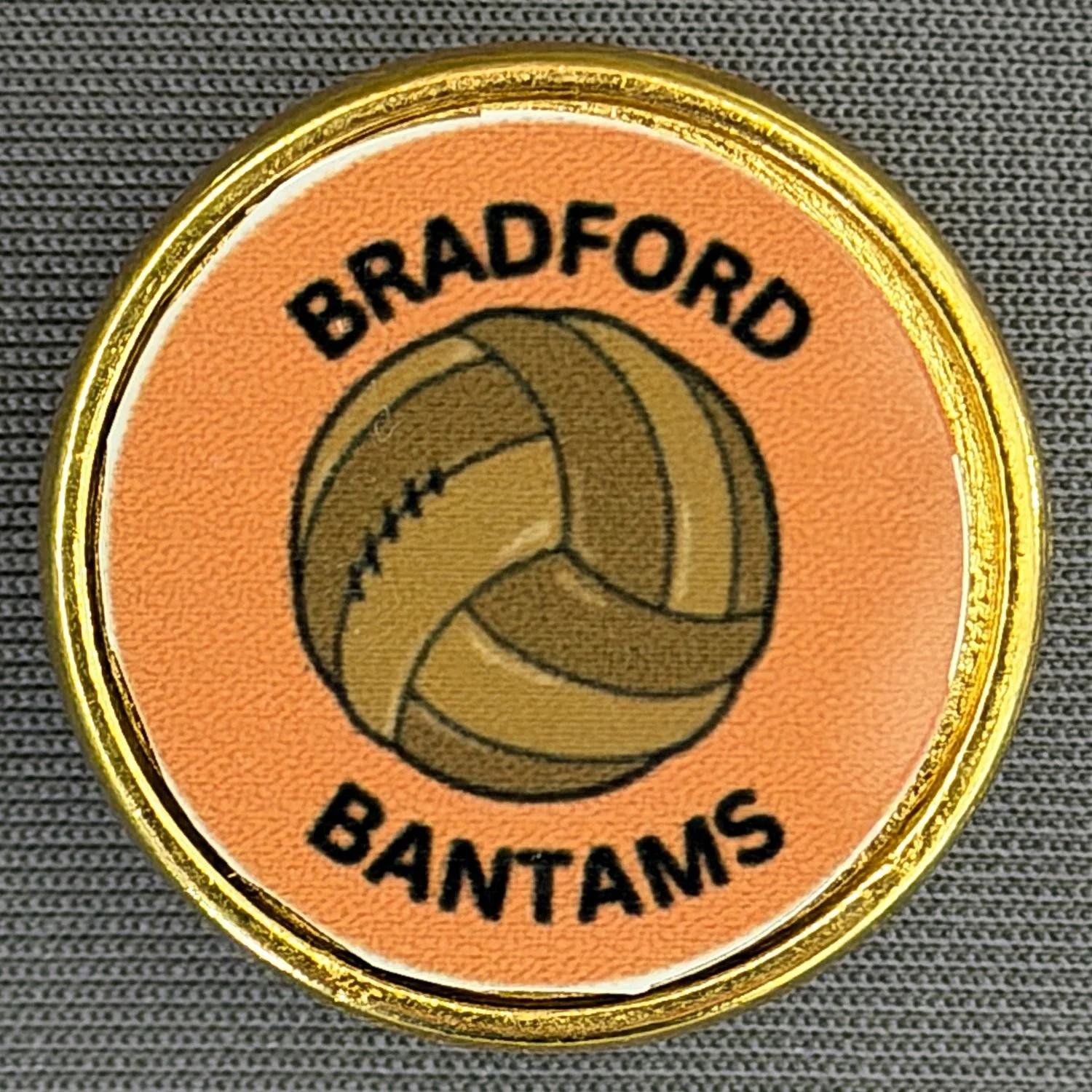 Close-up of a circular badge with a gold border, featuring a basketball graphic and the words 'BRAFORD BANTAMS' on an orange background.