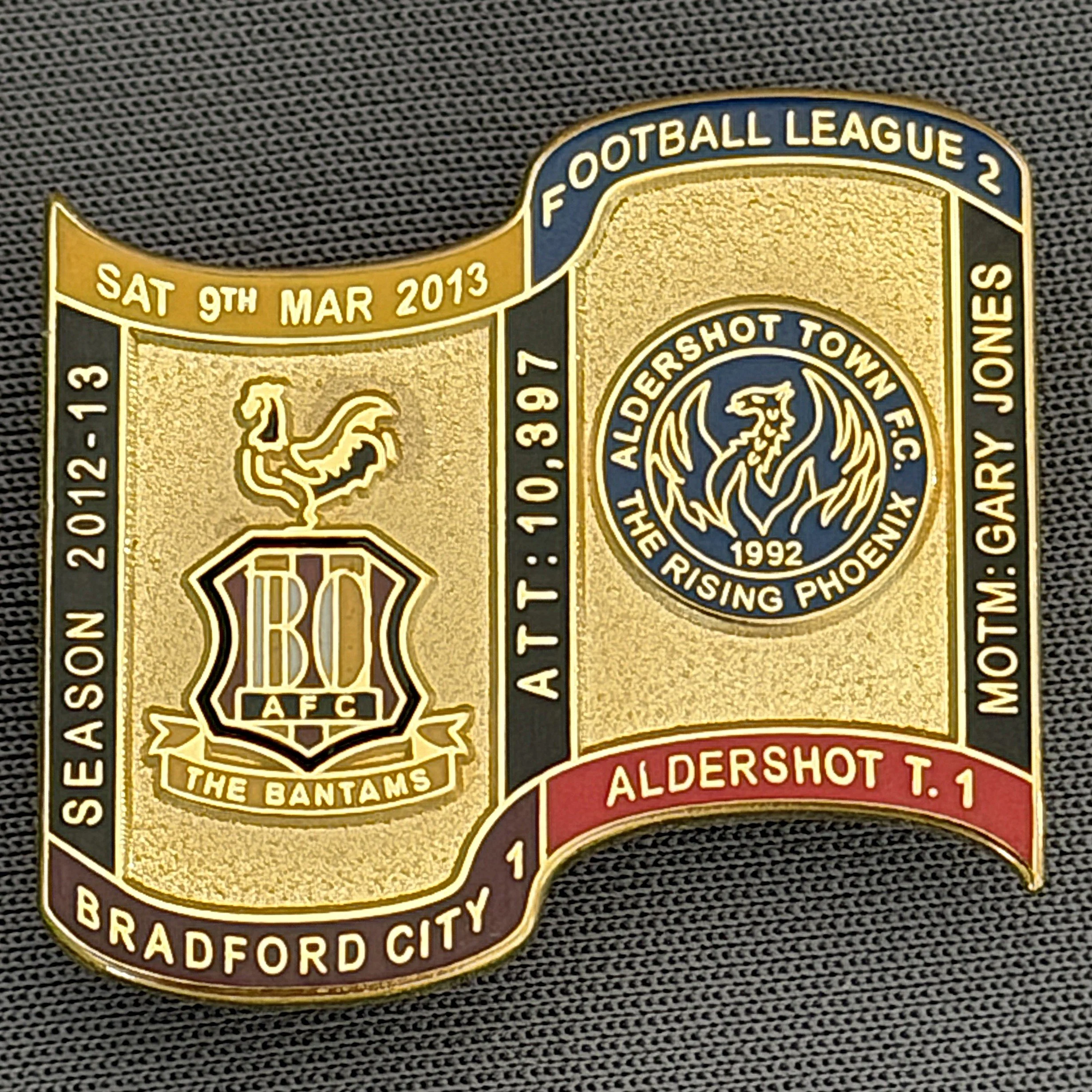Reference Number: BCFIX132
Size: H 26.9 mm x W 29.2 mm
Pin Type: Brooch Pin
Plating: Gold
Value: £8
Manufacturer: Bradford City Badges
Comments: Bradford City v Aldershot Town 2012/13 Limited Edition 65 Badges