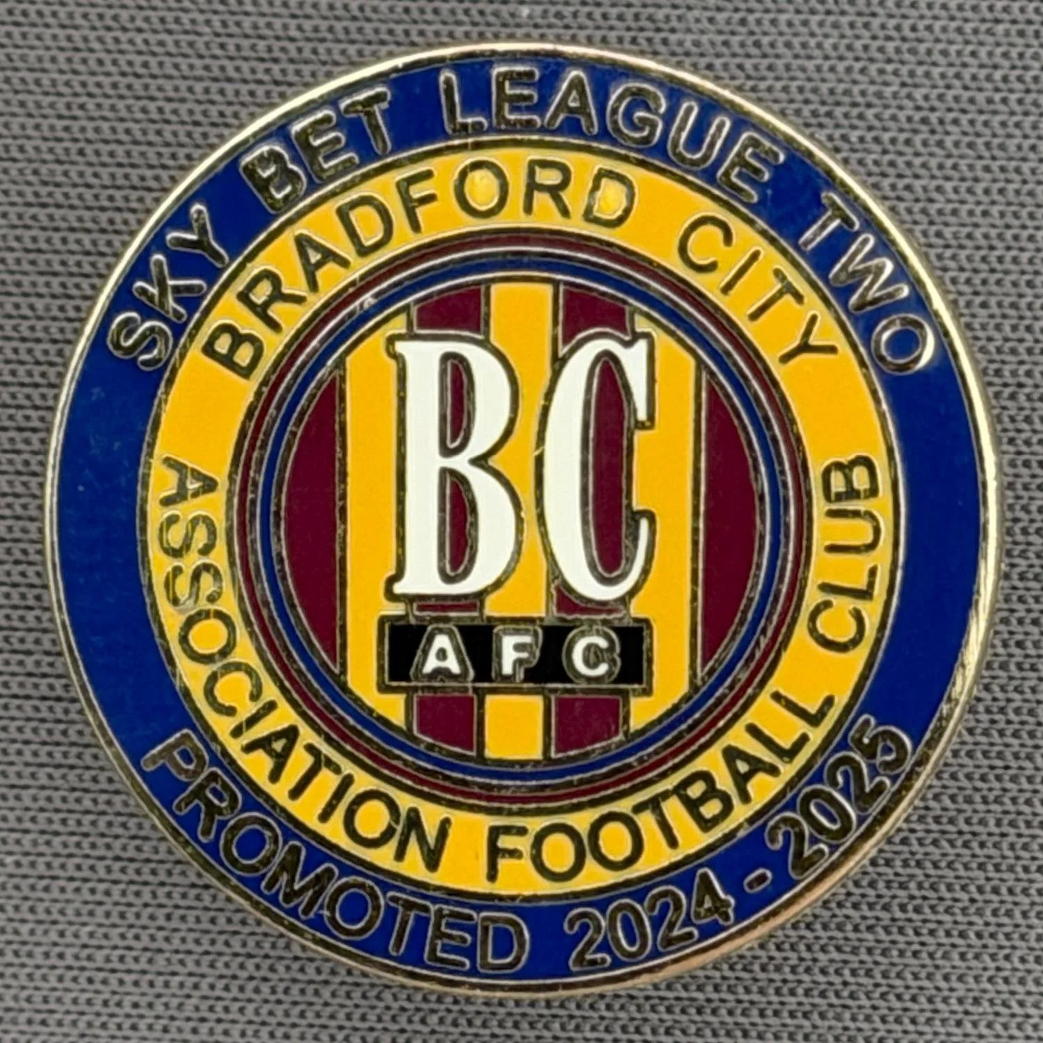 Reference Number: BCEVE075
Size: D 24.2 mm
Pin Type: Metal Clutch
Plating: Gold
Value: £8
Manufacturer: Dave Horn
Comments: Promoted From Division 2, 2024-25, Blue, Claret & Amber. Boxed Set Limited Edition of 75