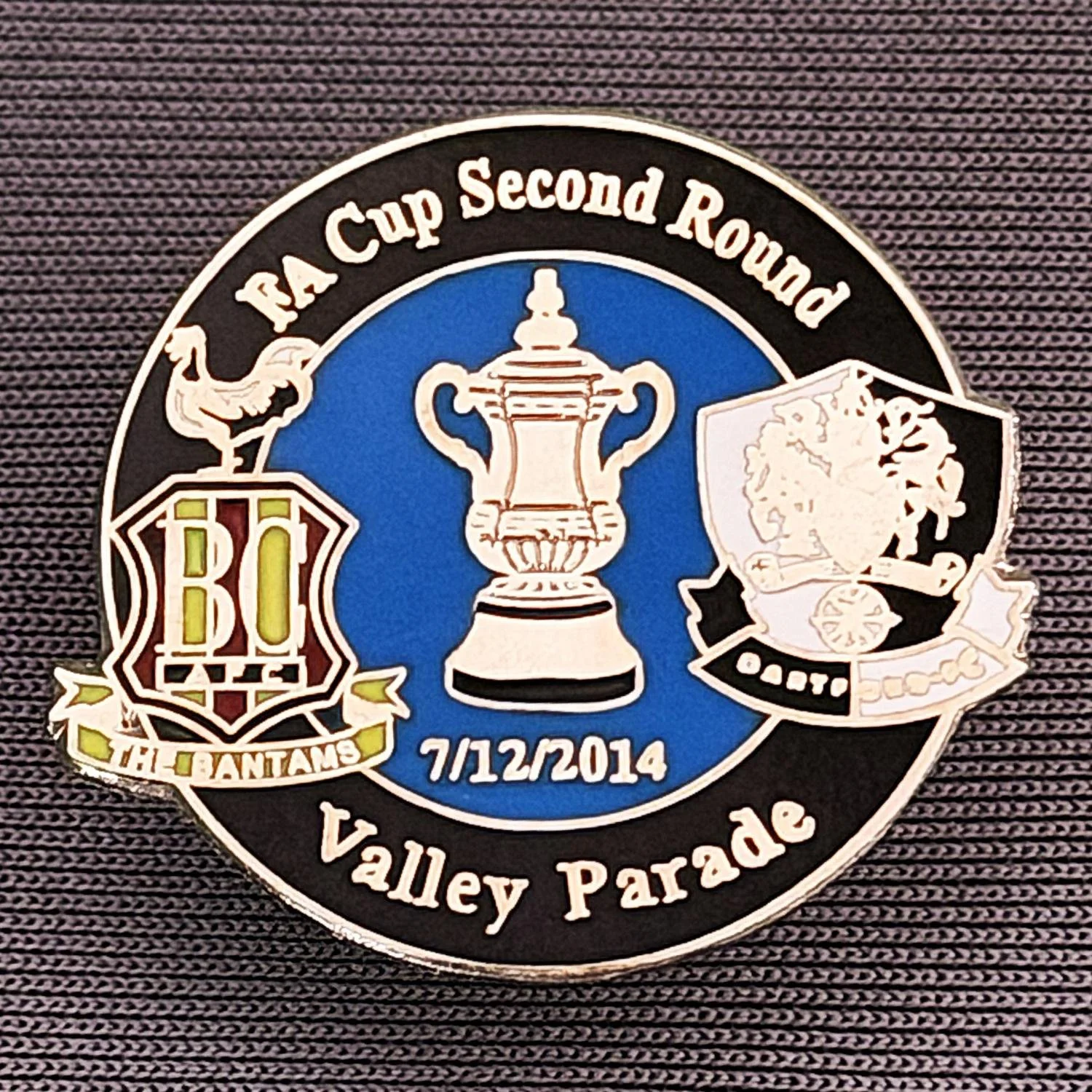 Reference Number: BCFAC068
Size: H 23.3 mm x W 25.6 mm
Pin Type: Metal Clutch
Plating: Silver
Value: £4
Manufacturer: Dan Lloyd
Comments: F.A. Cup Second Round 2014/15, v Dartford, Black & Blue Version