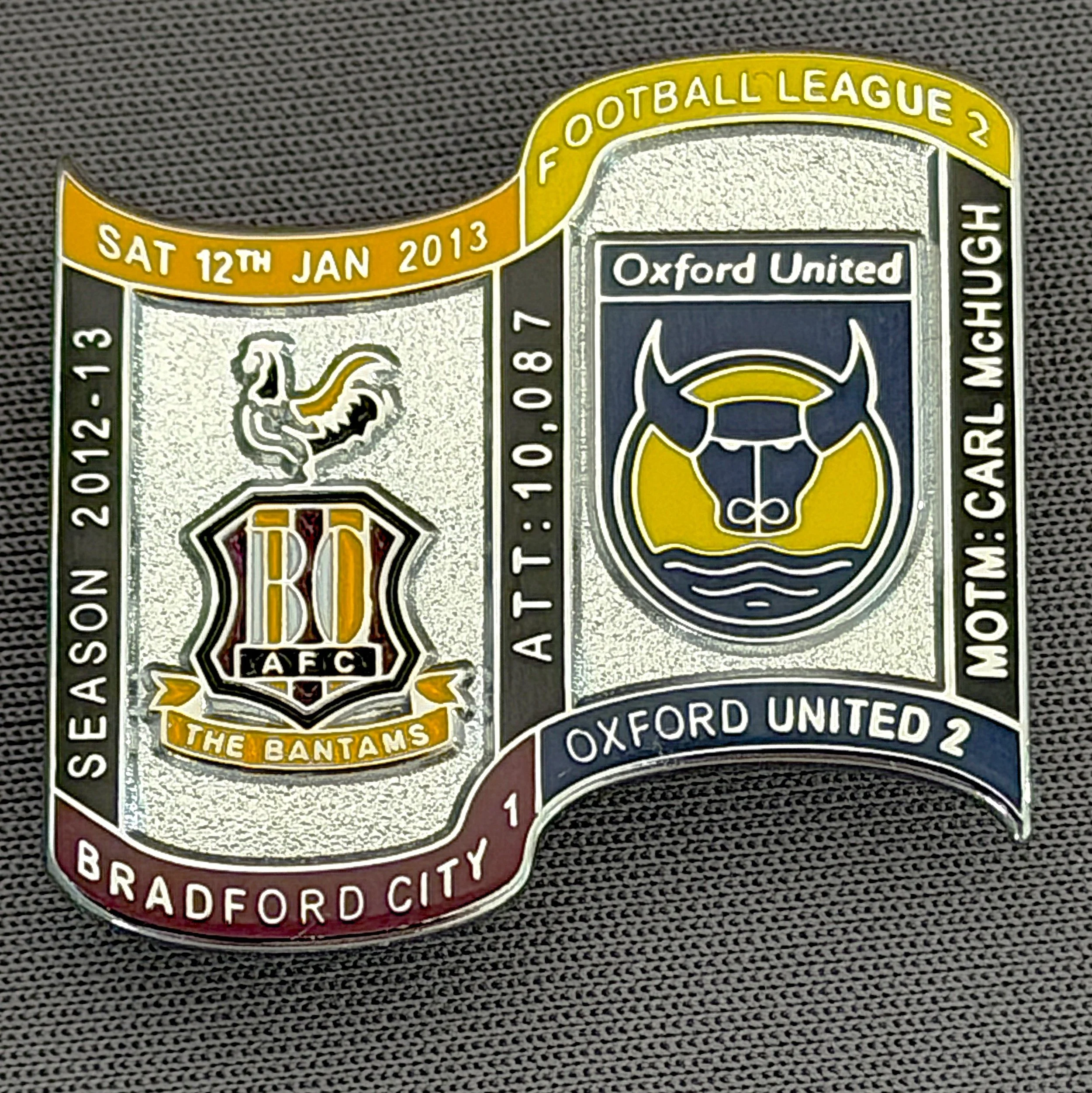 Reference Number: BCFIX152
Size: H 26.9 mm x W 29.2 mm
Pin Type: Brooch Pin
Plating: Chrome
Value: £10
Manufacturer: Bradford City Badges
Comments: Bradford City v Oxford United  2012/13 Limited Edition 10 Badges (Silver Version)