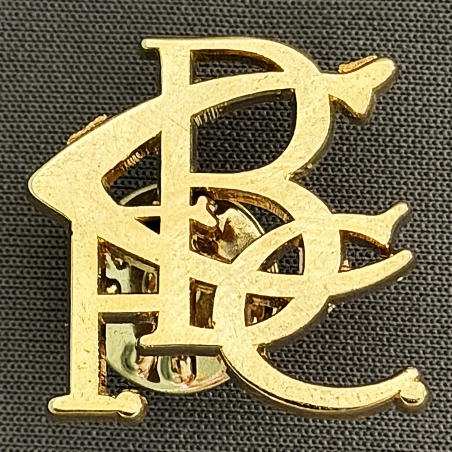 Reference Number: BCC&L065
Size: H 21.8 mm x 23.5 mm
Pin Type: Metal Clutch
Plating: Gold
Value: £6
Manufacturer: Unknown
Comments: BCFC Scroll Gold