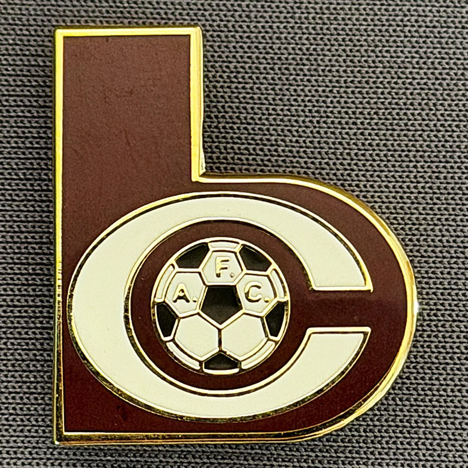 Reference Number: BCC&L152
Size: H 22.8 mm x 19.7 mm
Pin Type: Brooch Pin
Plating: Gold
Value: £6
Manufacturer: Unknown
Comments: Shaped Dark Claret & White BC Logo