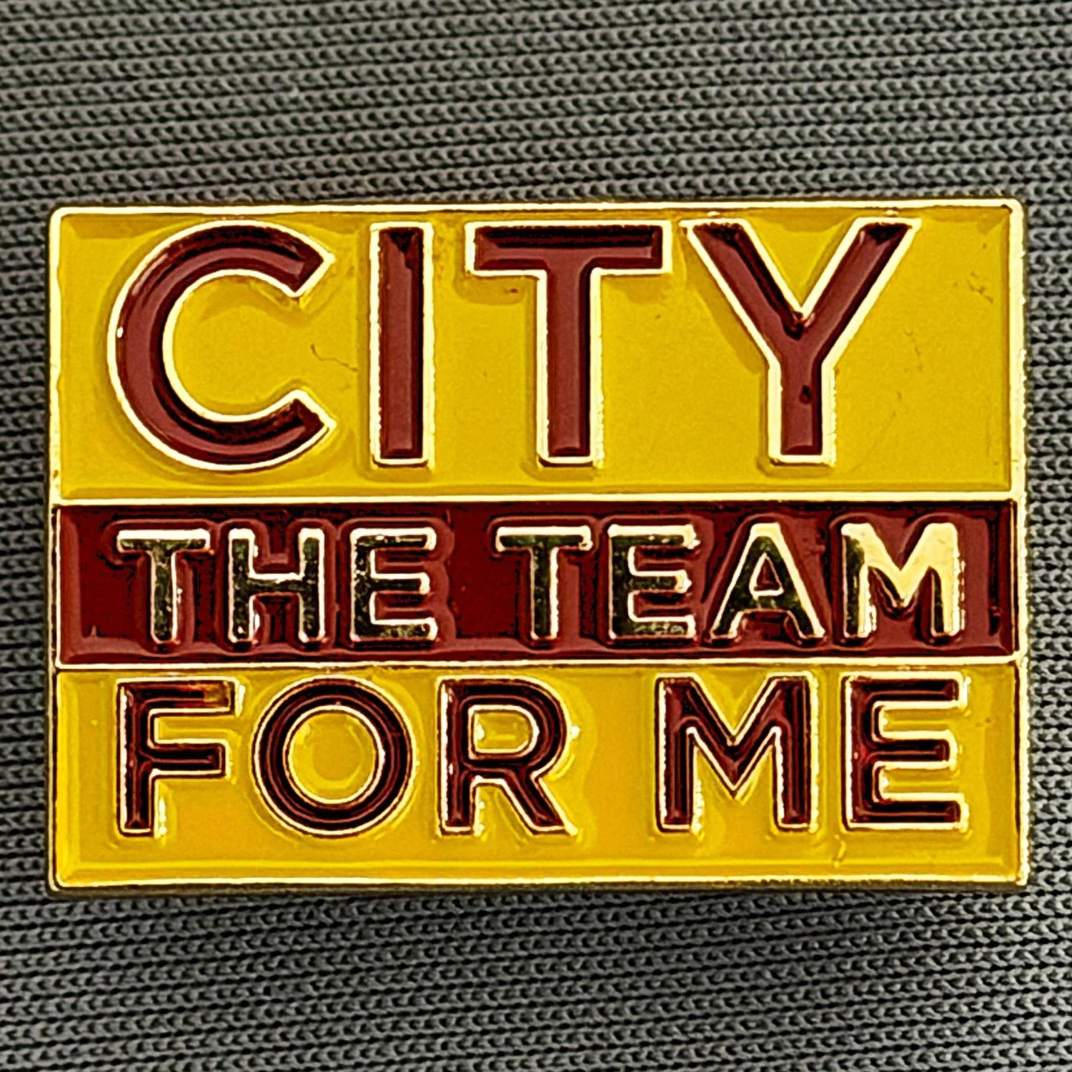 Reference Number: BCBCFC066
Size: H 17.1 mm x W 24.3 mm
Pin Type: Metal Clutch
Plating: Gold
Value: £4
Manufacturer: Unknown
Comments: Amber, Claret & Amber City The Team For Me