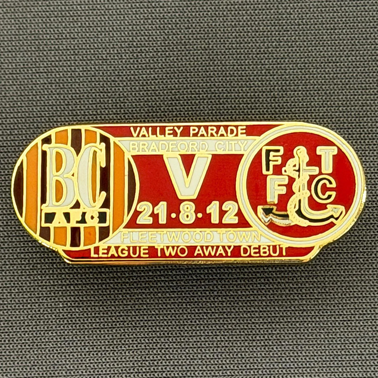 Reference Number: BCOFIX132
Size: H 14.4 mm x W 35.1 mm
Pin Type: Double Rubber Clutch
Plating: Gold
Value: £5
Manufacturer: Unknown
Comments: Bradford City v Fleetwood Town 2012 League Two Debut, Red & White Version 