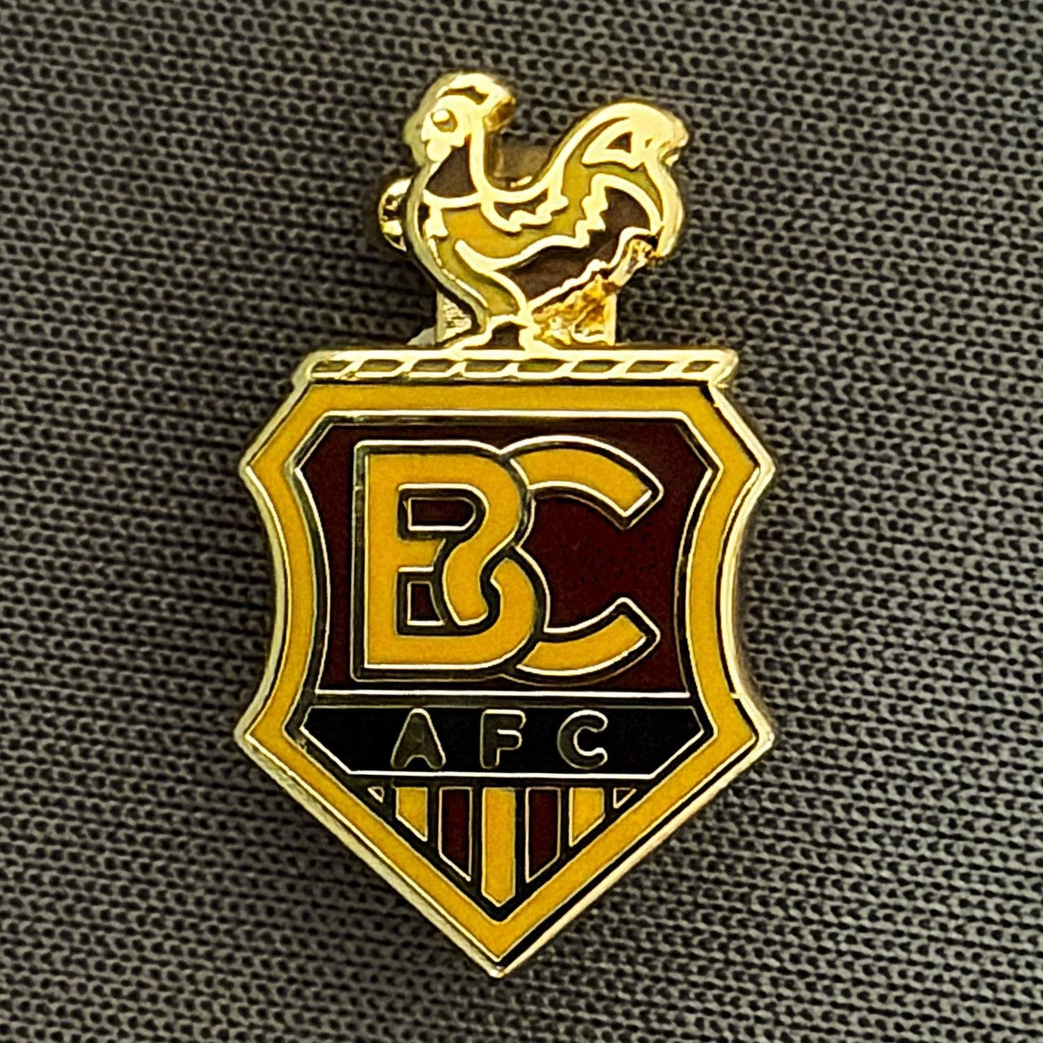 Reference Number: BCC&L110
Size: H 18.3 mm x W 11.1 mm
Pin Type: Brooch Pin
Plating: Gold
Value: £6
Manufacturer: Unknown
Comments: BCAFC Crest  Dark Claret & Amber