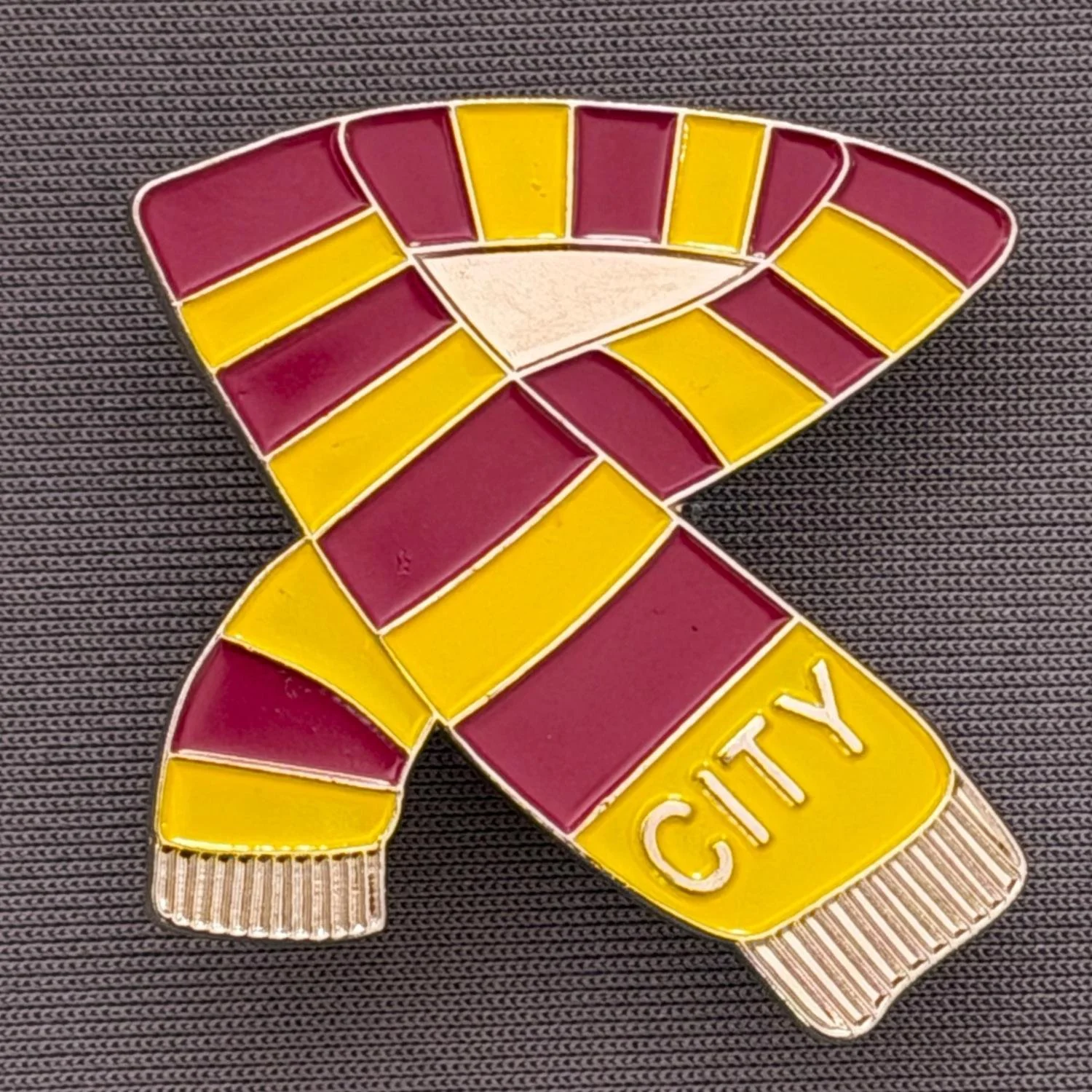 Reference Number: BCSCA001
Size: H 32.8 mm x W 32.6 mm
Pin Type: Plastic Clutch 
Plating: Silver
Value: £6
Manufacturer: Unknown
Comments: Large Claret & Amber City Scarf