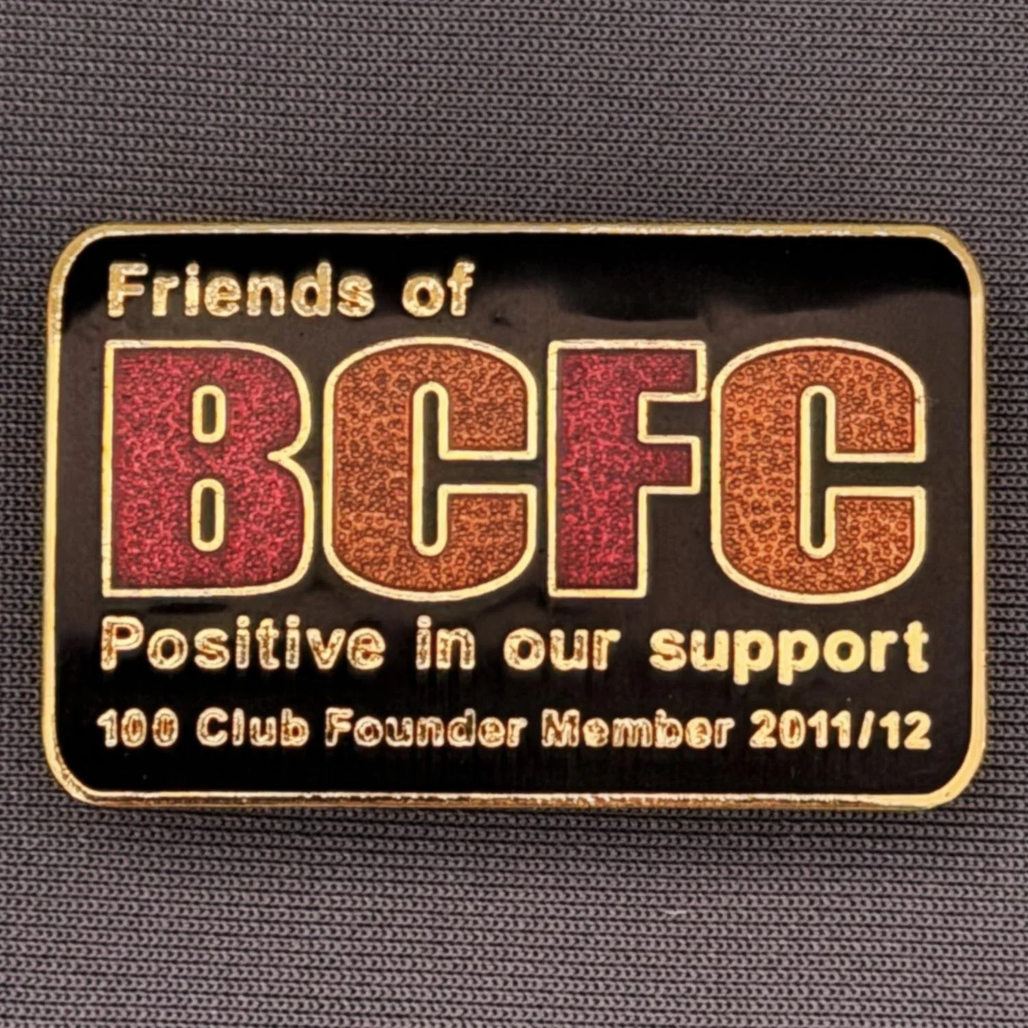 Reference Number: BCSUP040
Size: H 23.6 mm x W 37.9 mm
Pin Type: Brooch Pin
Plating: Gold
Value: £15
Manufacturer: Black Dragon
Comments: Friends of Bradford City 100 Club Founder Member 2011/12