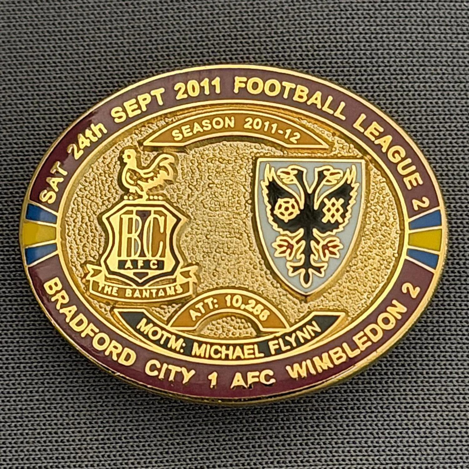 Reference Number: BCFIX074
Size: H 23.6 mm x W 28.7 mm
Pin Type: Brooch Pin
Plating: Gold
Value: £8
Manufacturer: Bradford City Badges
Comments: Bradford City v A.F.C. Wimbledon 2011/12 Limited Edition 80 Badges